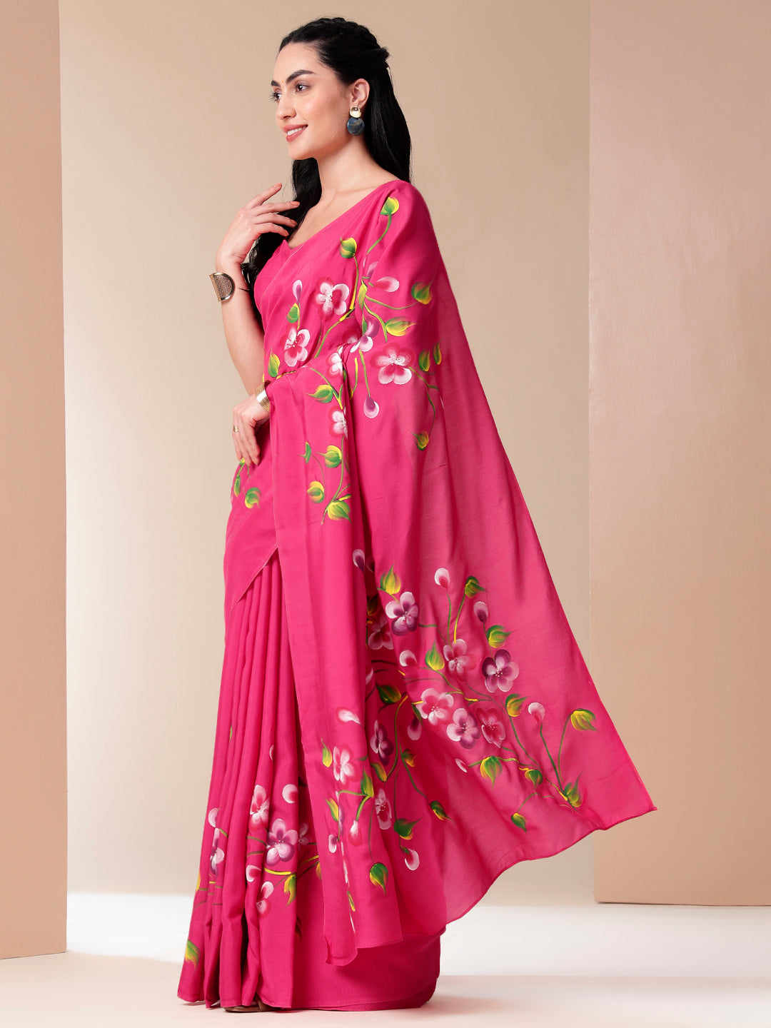 Elegant pink saree for parties featuring beautiful floral embroidery and stylish draping