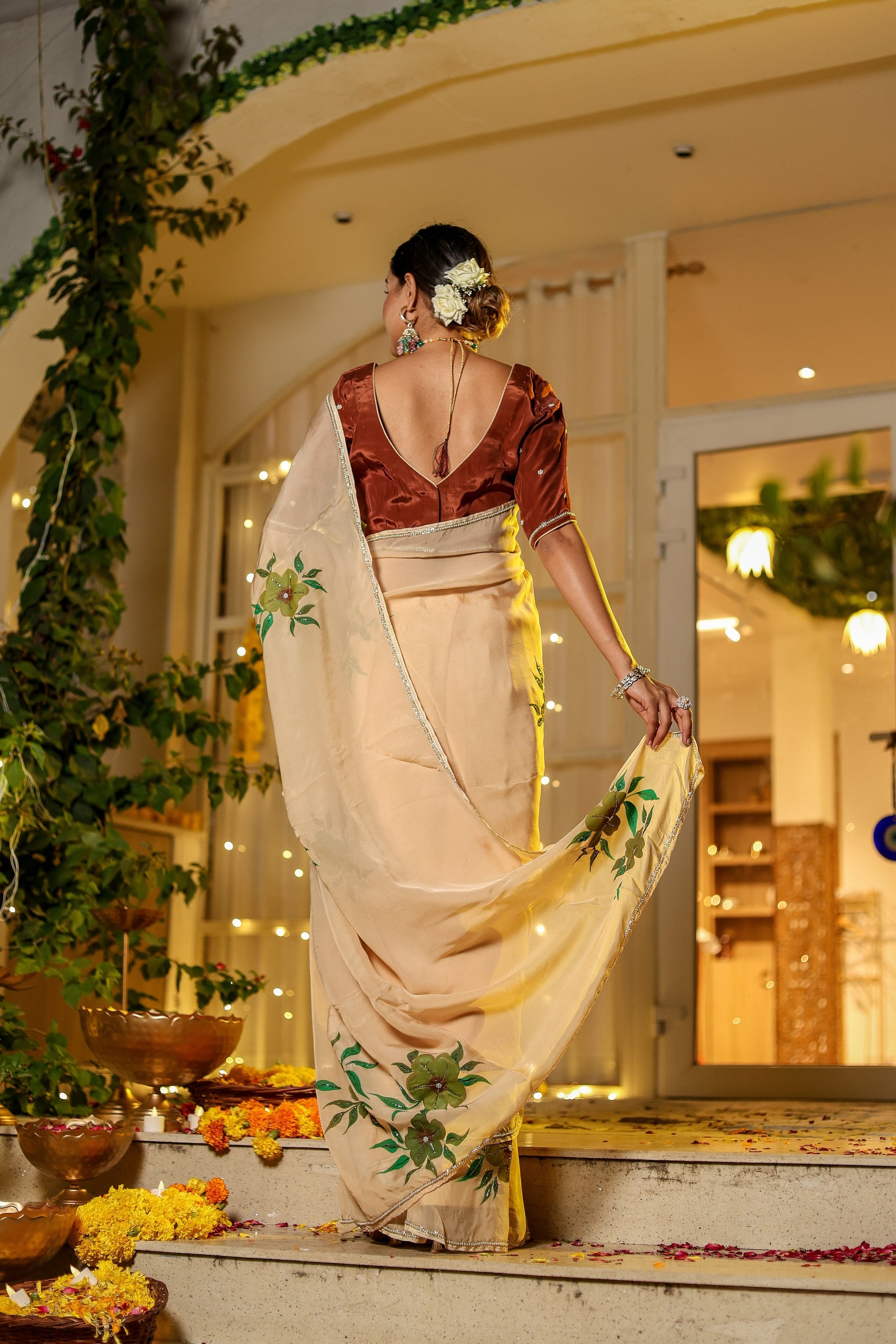 Elegant woman wearing an exclusive handmade Indian saree with intricate floral design, showcasing traditional beauty
