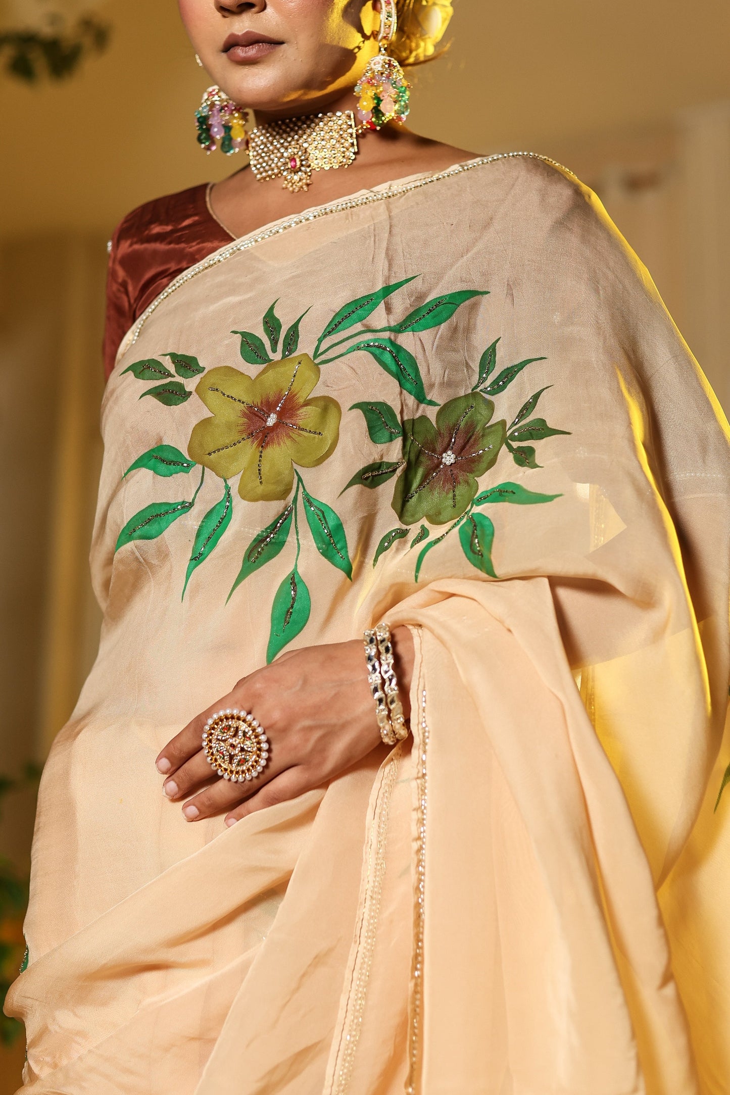 Exclusive handmade Indian saree in soft beige with vibrant floral embroidery for elegant occasions