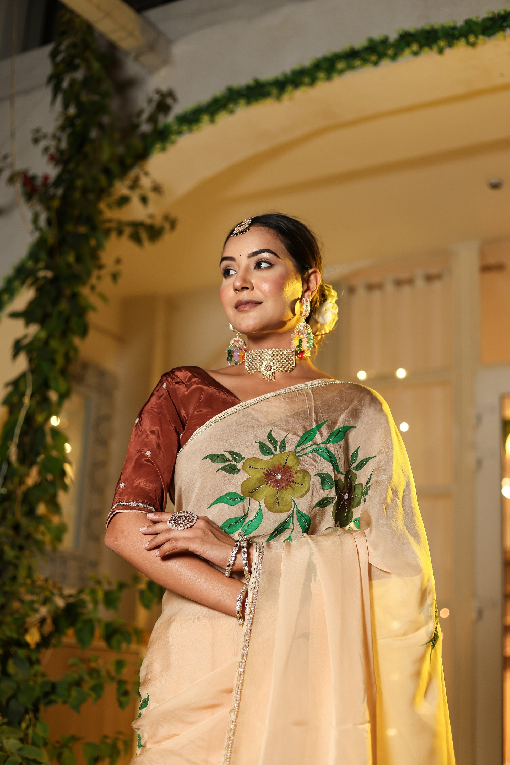 Elegant model wearing an exclusive handmade Indian saree with floral embroidery and traditional accessories