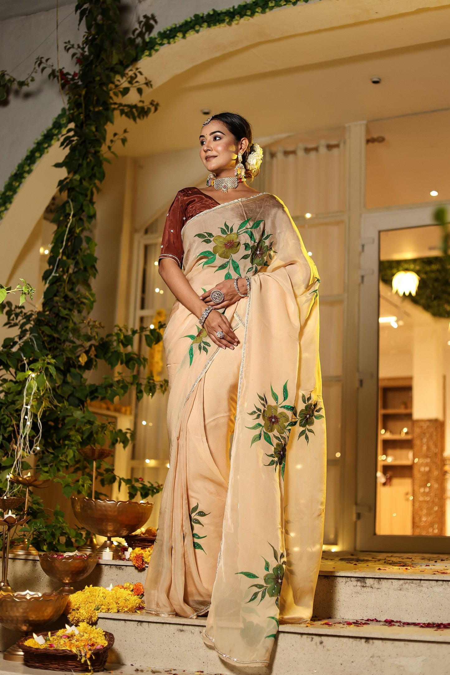Exclusive handmade Indian saree in beige with floral embroidery, elegantly draped for festive occasions