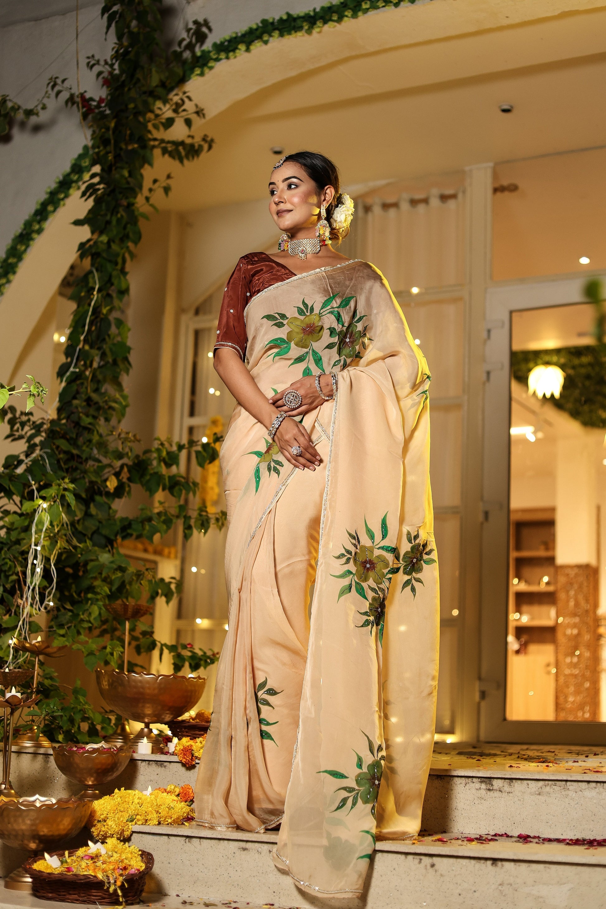 Exclusive handmade Indian saree in beige with floral embroidery, elegantly draped for festive occasions