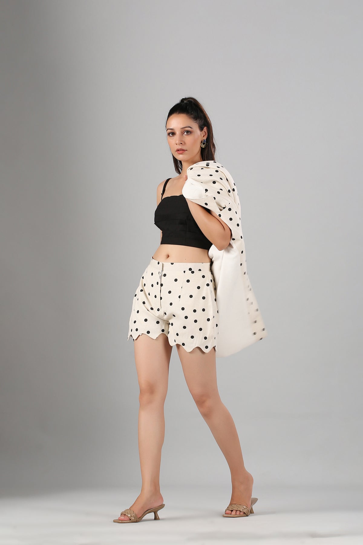 Model wearing Stylera's polka dot blazer and scalloped shorts with black crop top fashionable two piece suit for ladies