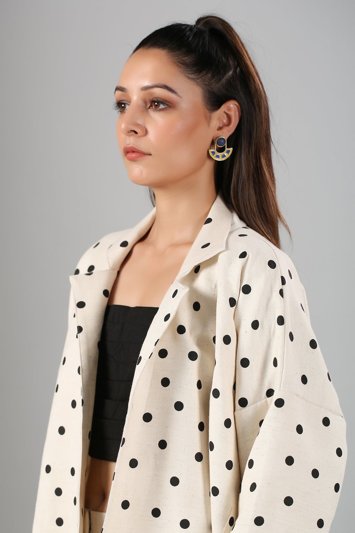 fashionable two piece suit for ladies cream polka dot jacket paired with black crop top and trousers