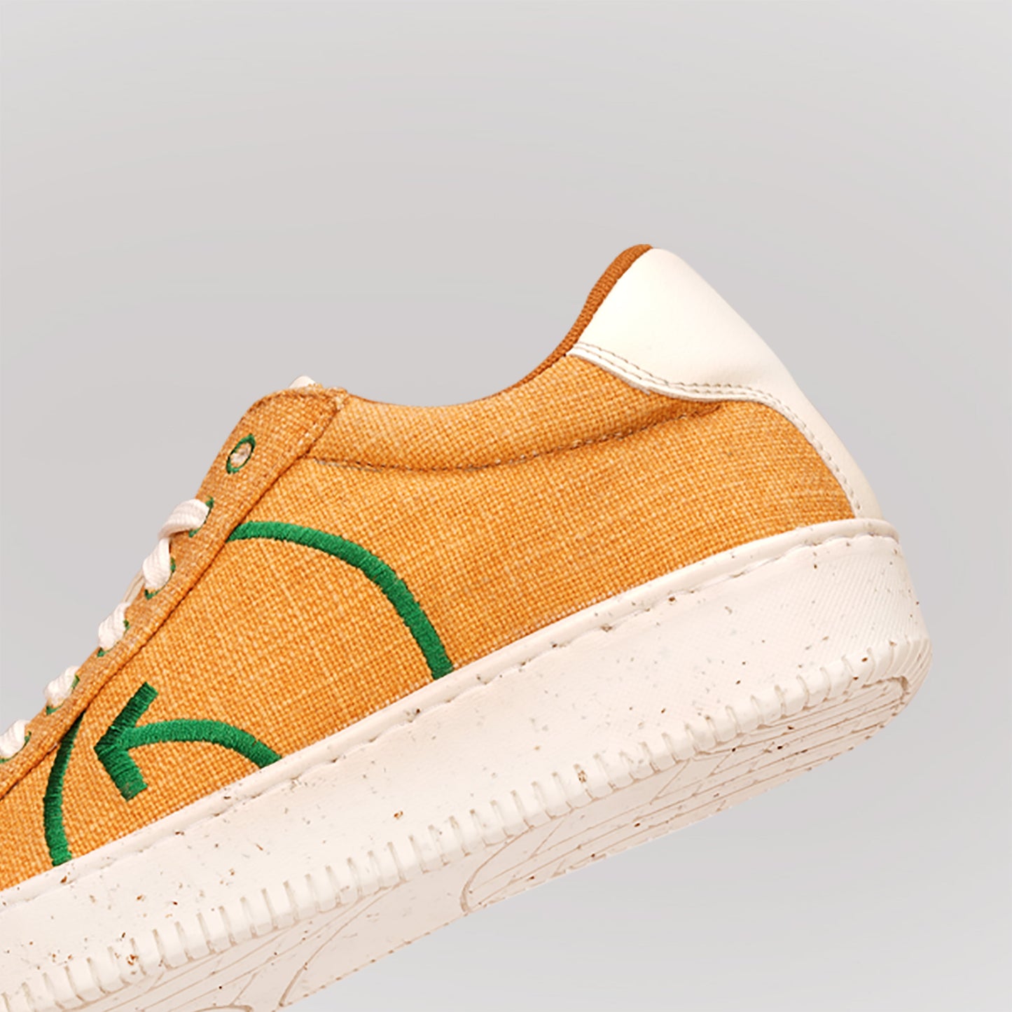 Fashionable yellow casual sneakers with eco-friendly design and textured finish from Stylera