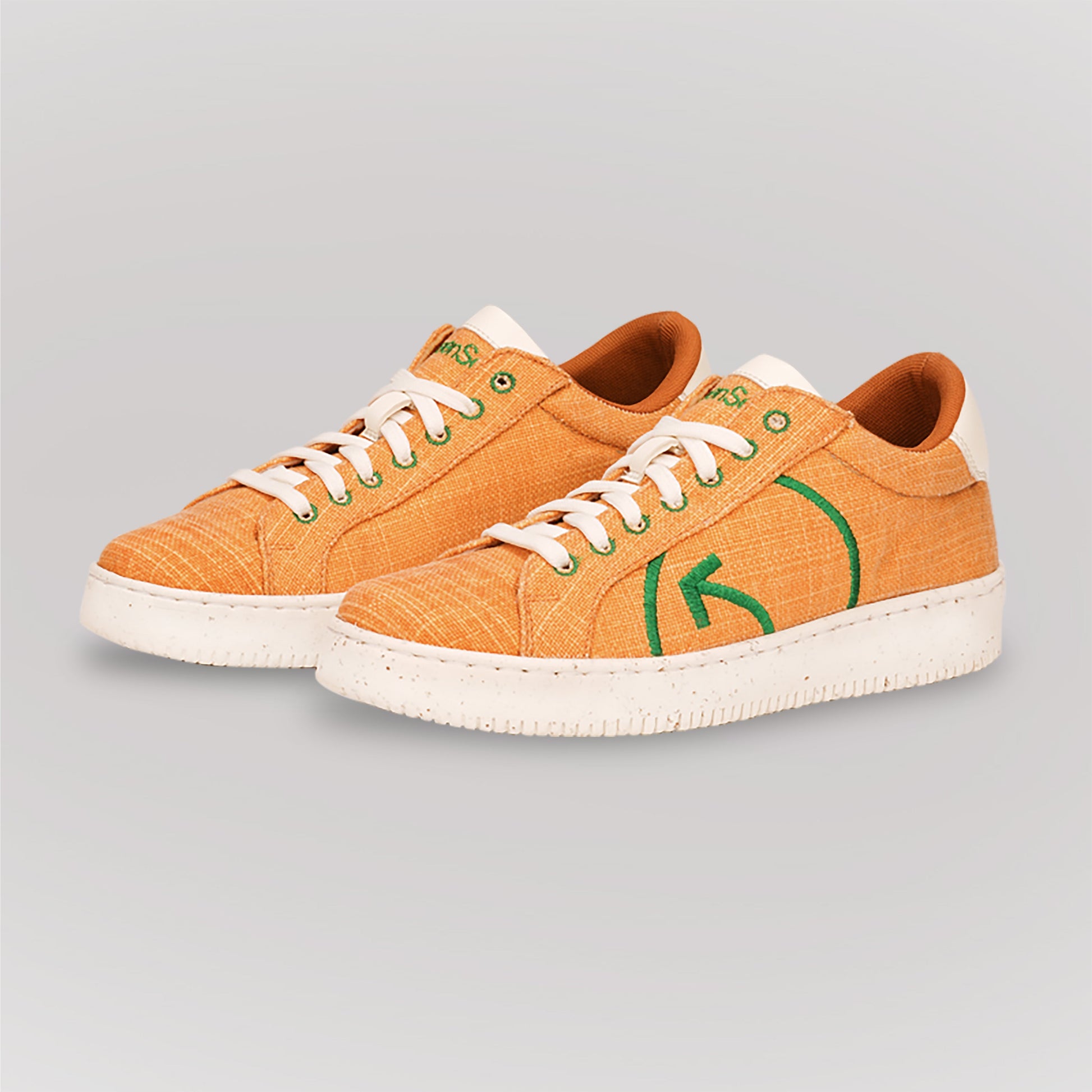 Fashionable yellow casual sneakers with green logo and white soles for trendy everyday wear