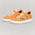 Fashionable yellow casual sneakers with green logo and white soles for trendy everyday wear