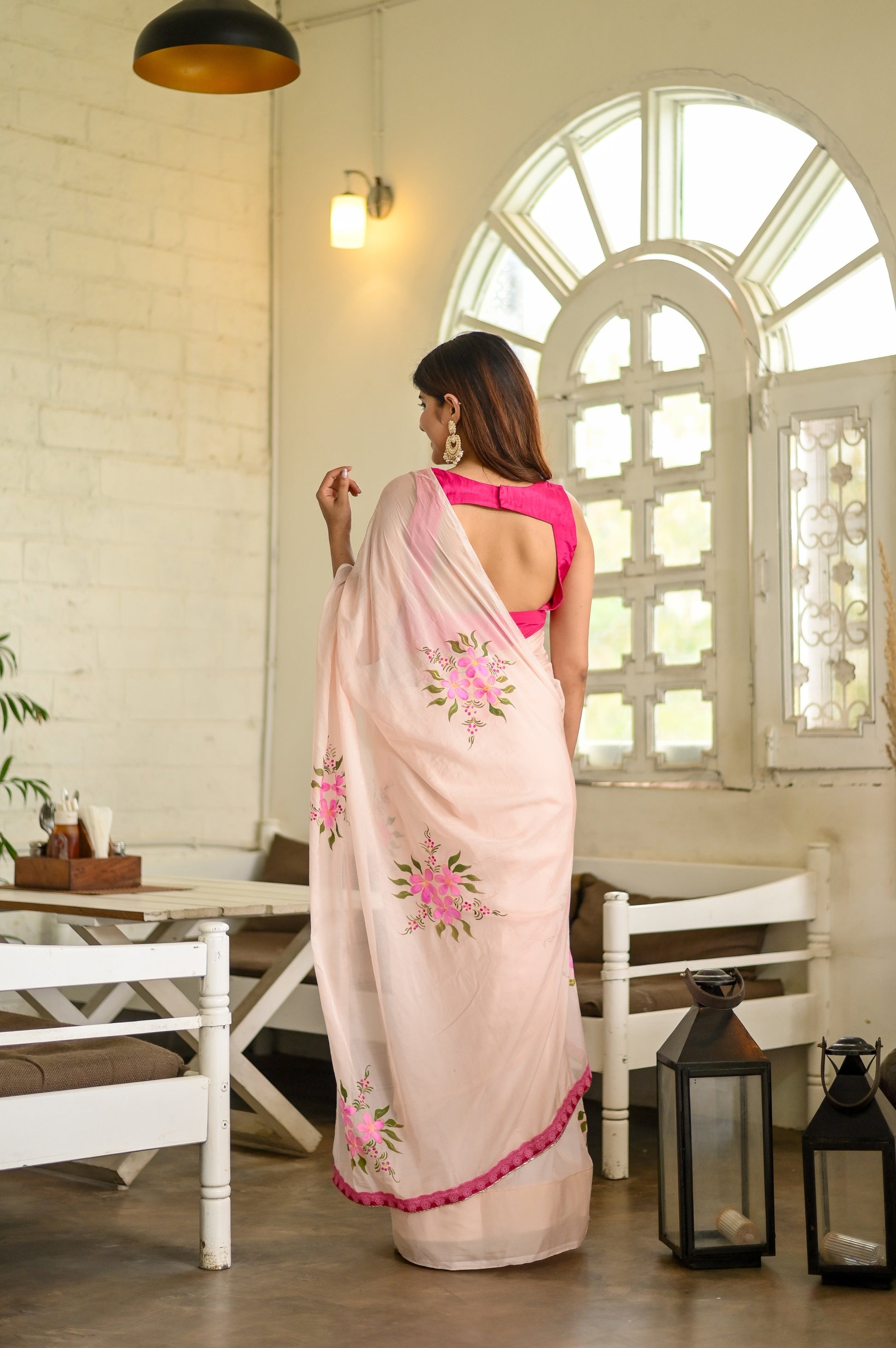 Elegant floral organza saree for women featuring delicate pink floral embroidery and a stylish back design