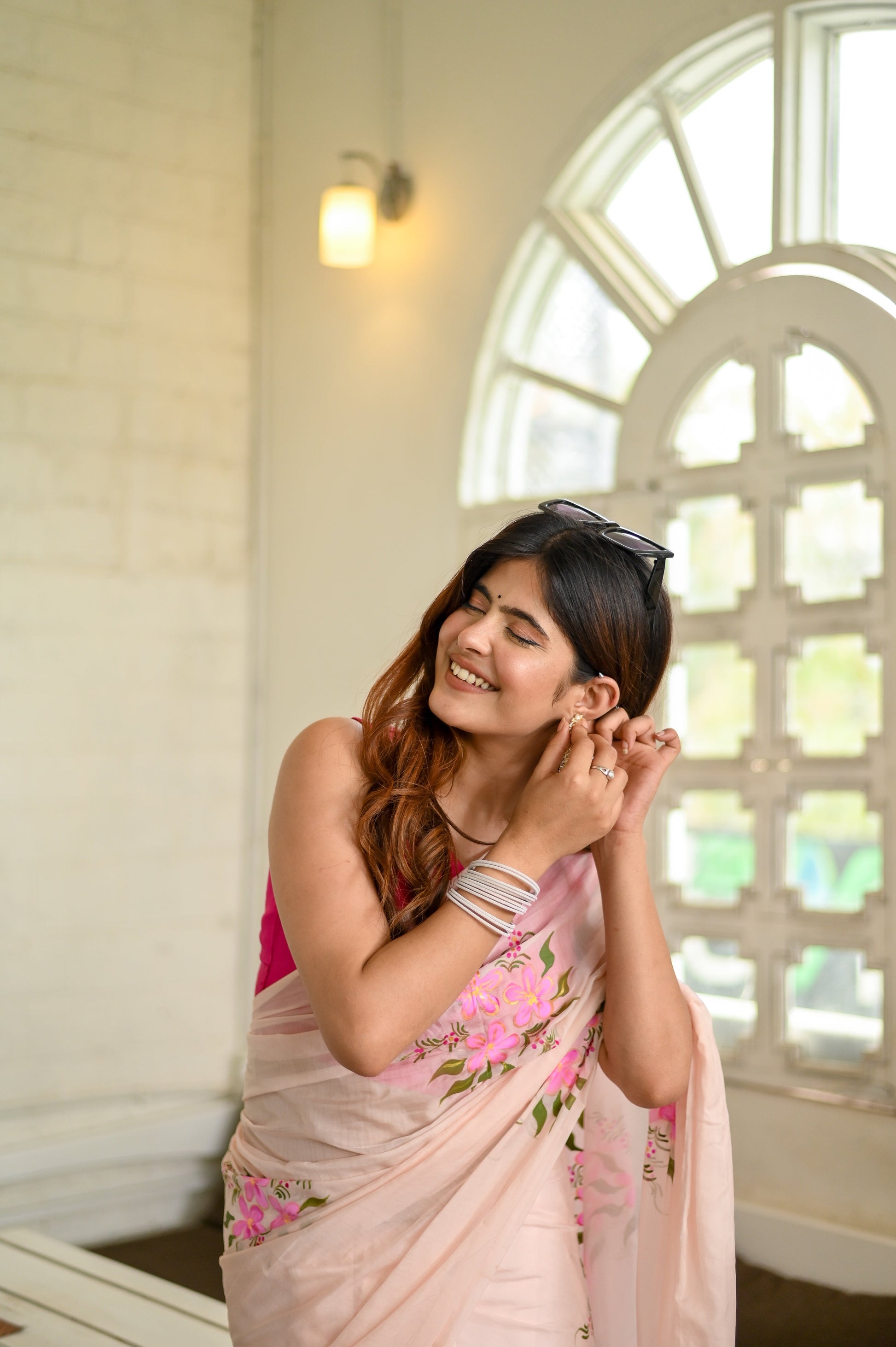 Elegant floral organza saree for women featuring delicate pink embroidery on a light fabric