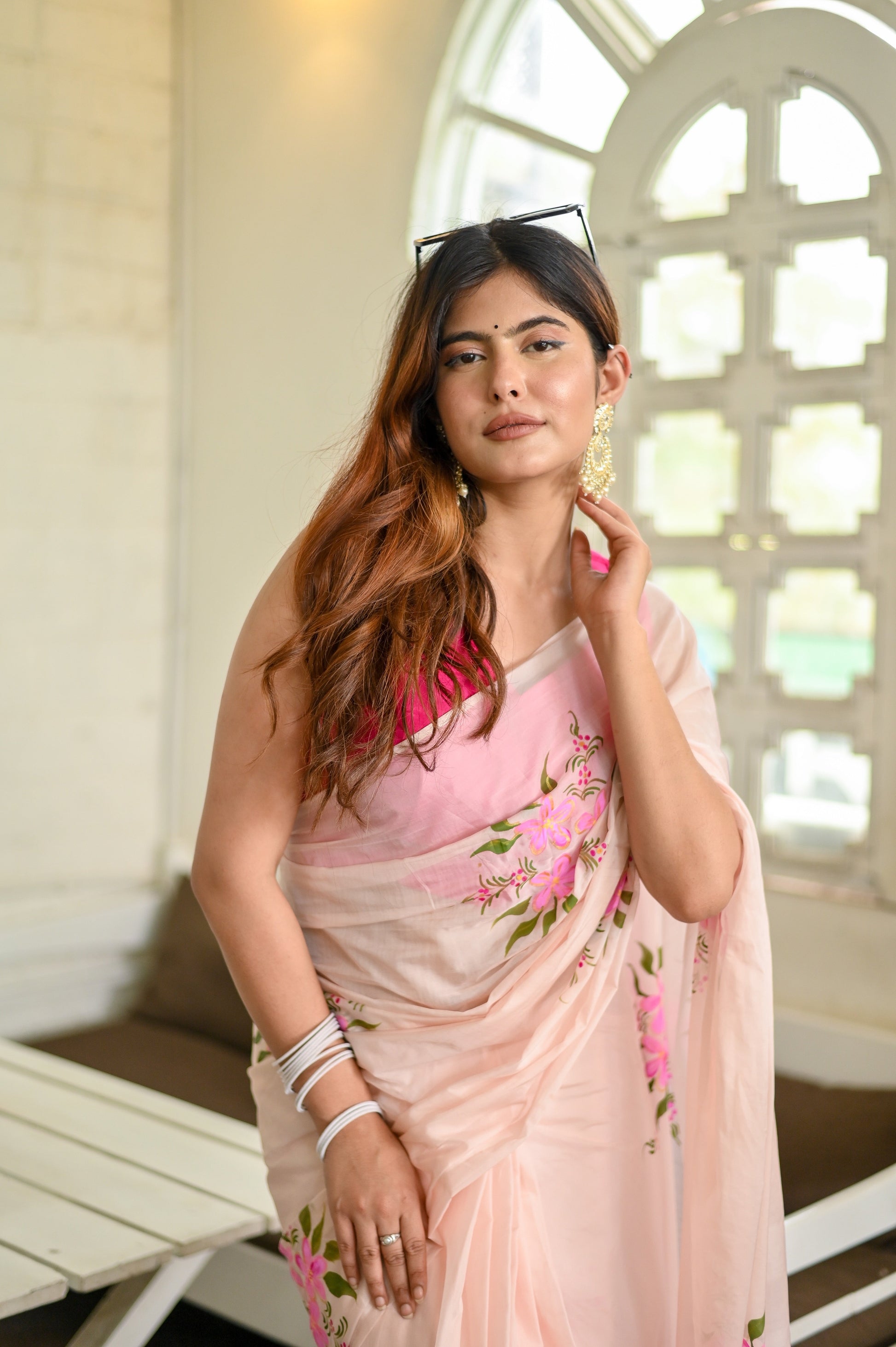 Elegant floral organza saree for women featuring vibrant pink floral patterns and a soft transparent texture