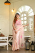 Floral organza saree for women in soft pink with vibrant floral embroidery, styled for a chic look