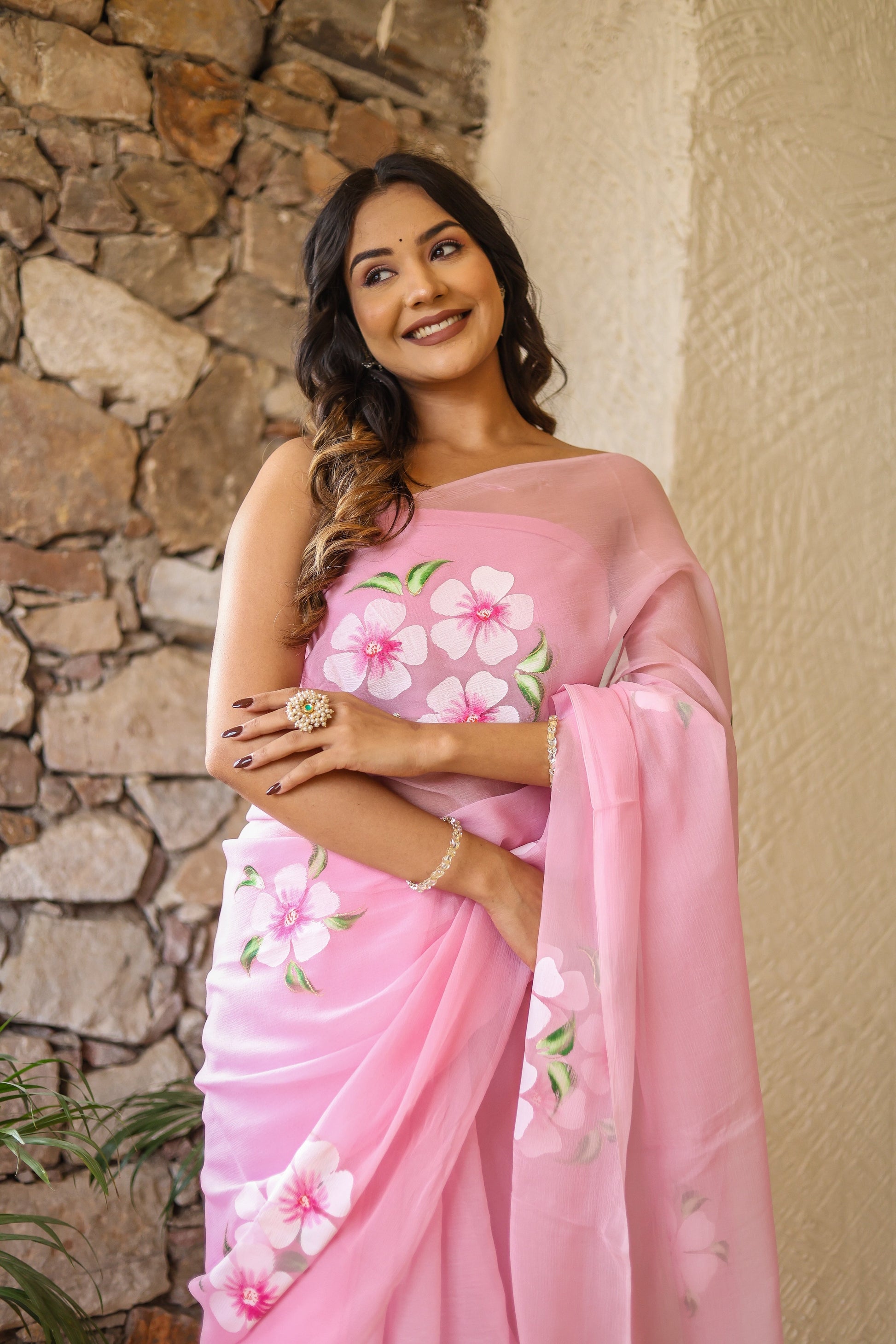 Floral pink saree for women featuring vibrant flower designs, perfect for festive occasions