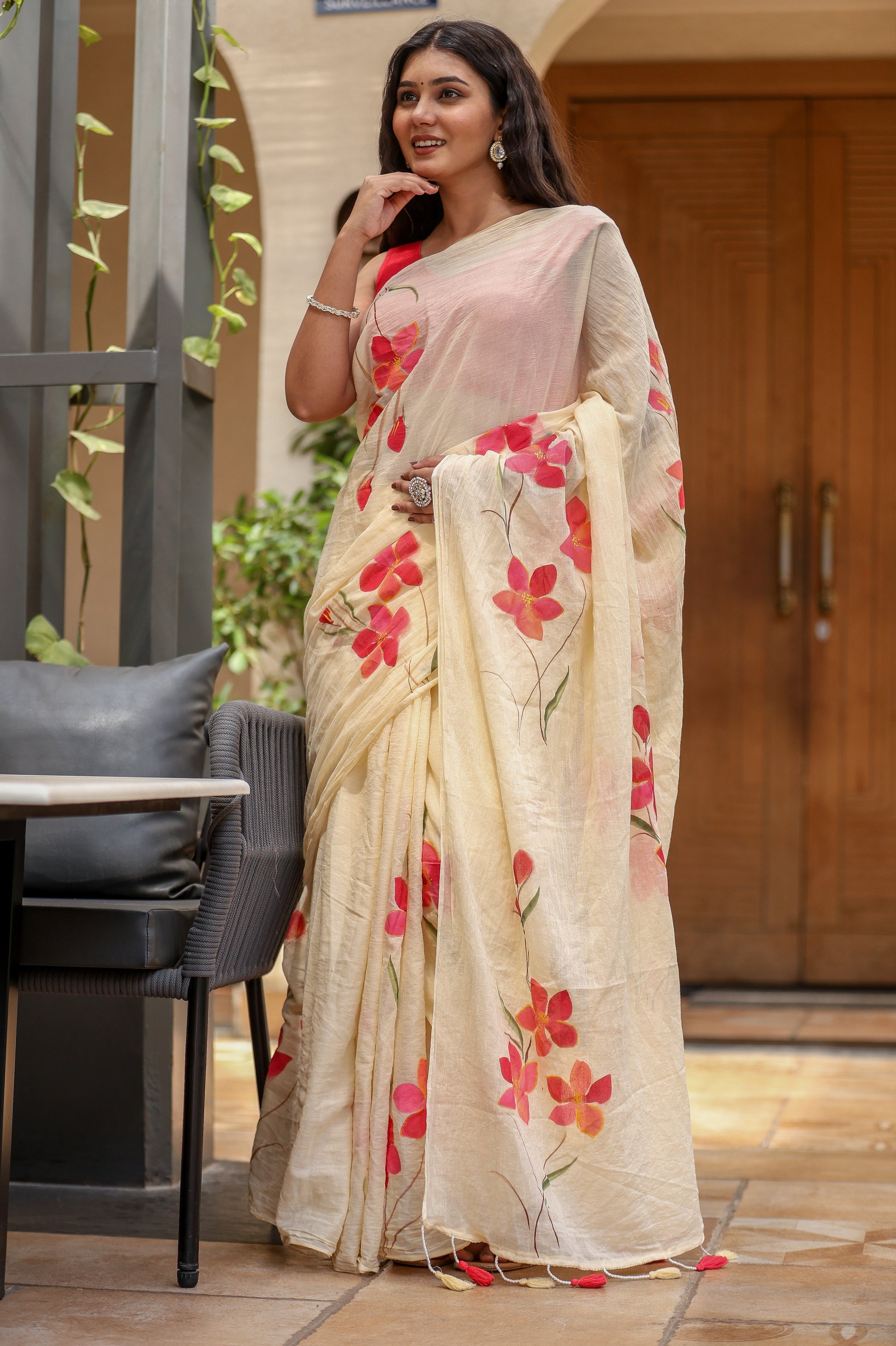 Elegant floral print cream saree with vibrant pink flowers for festive occasions