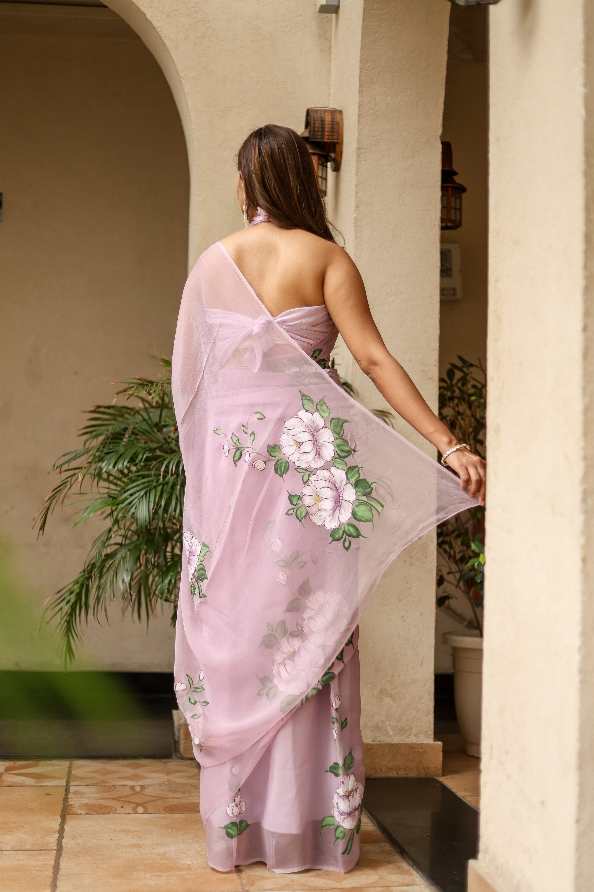 Elegant floral statement saree in soft pink with intricate floral patterns and flowing chiffon pallu