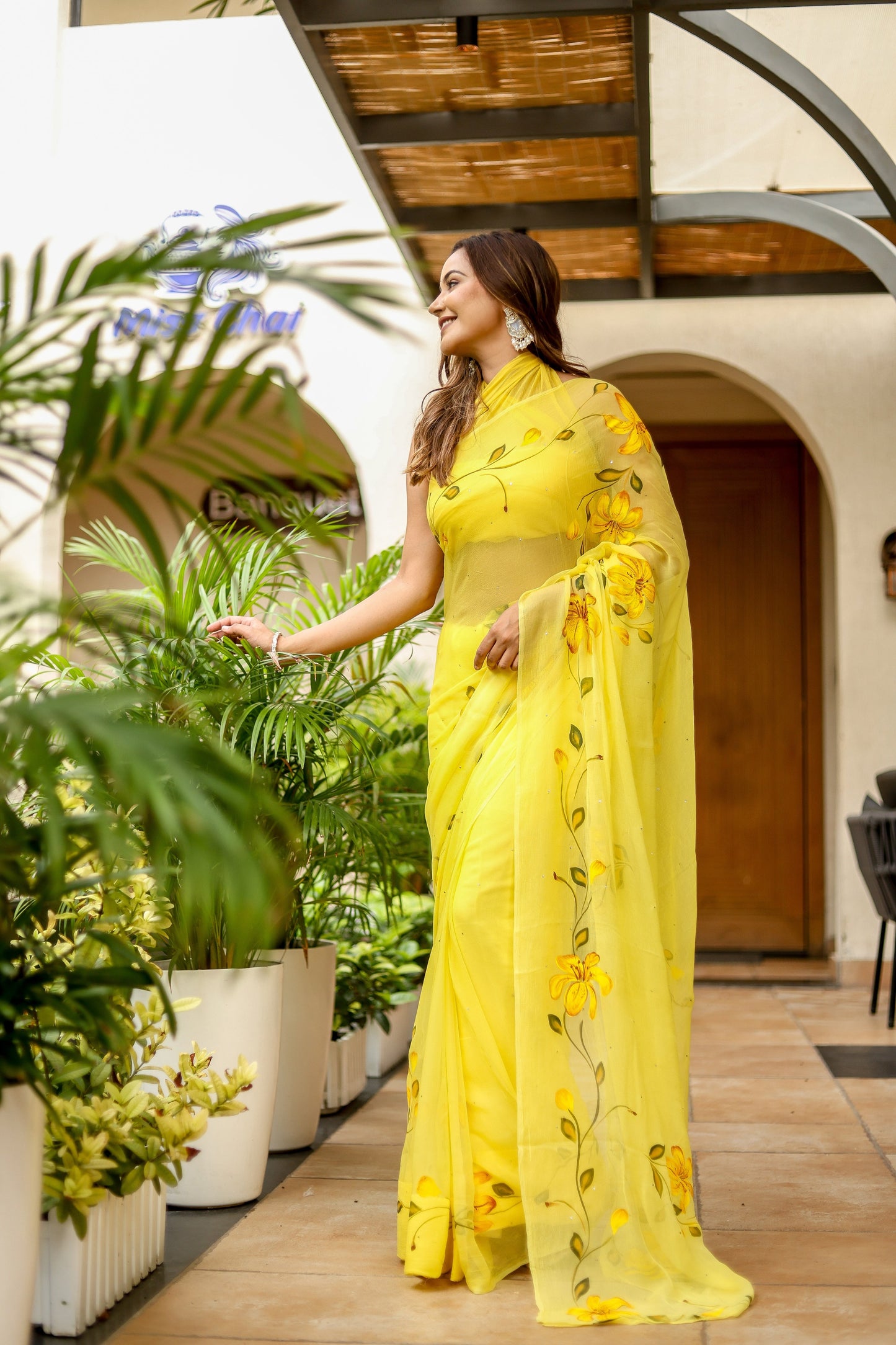 Elegant floral viscose chiffon saree with mukaish work in vibrant yellow colors perfect for festive occasions