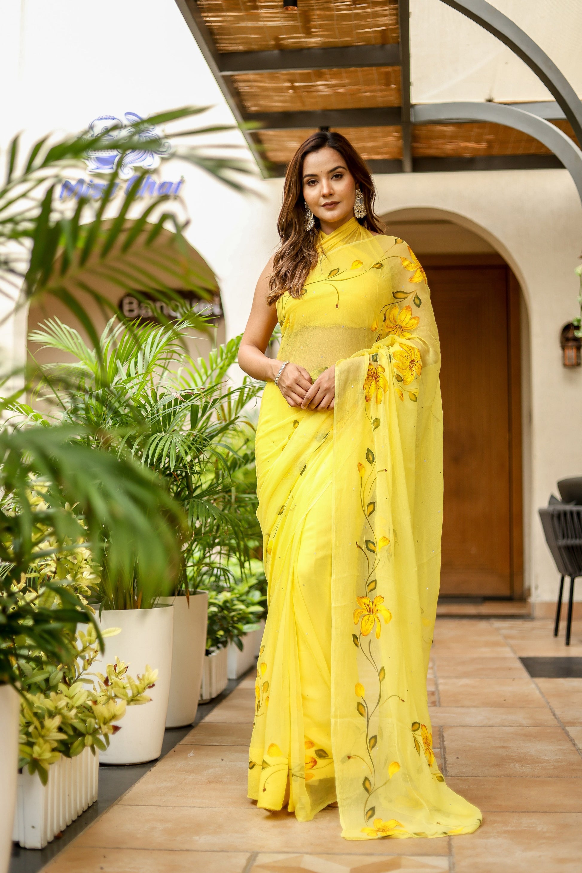 Yellow floral viscose chiffon saree with mukaish work perfect for elegant occasions