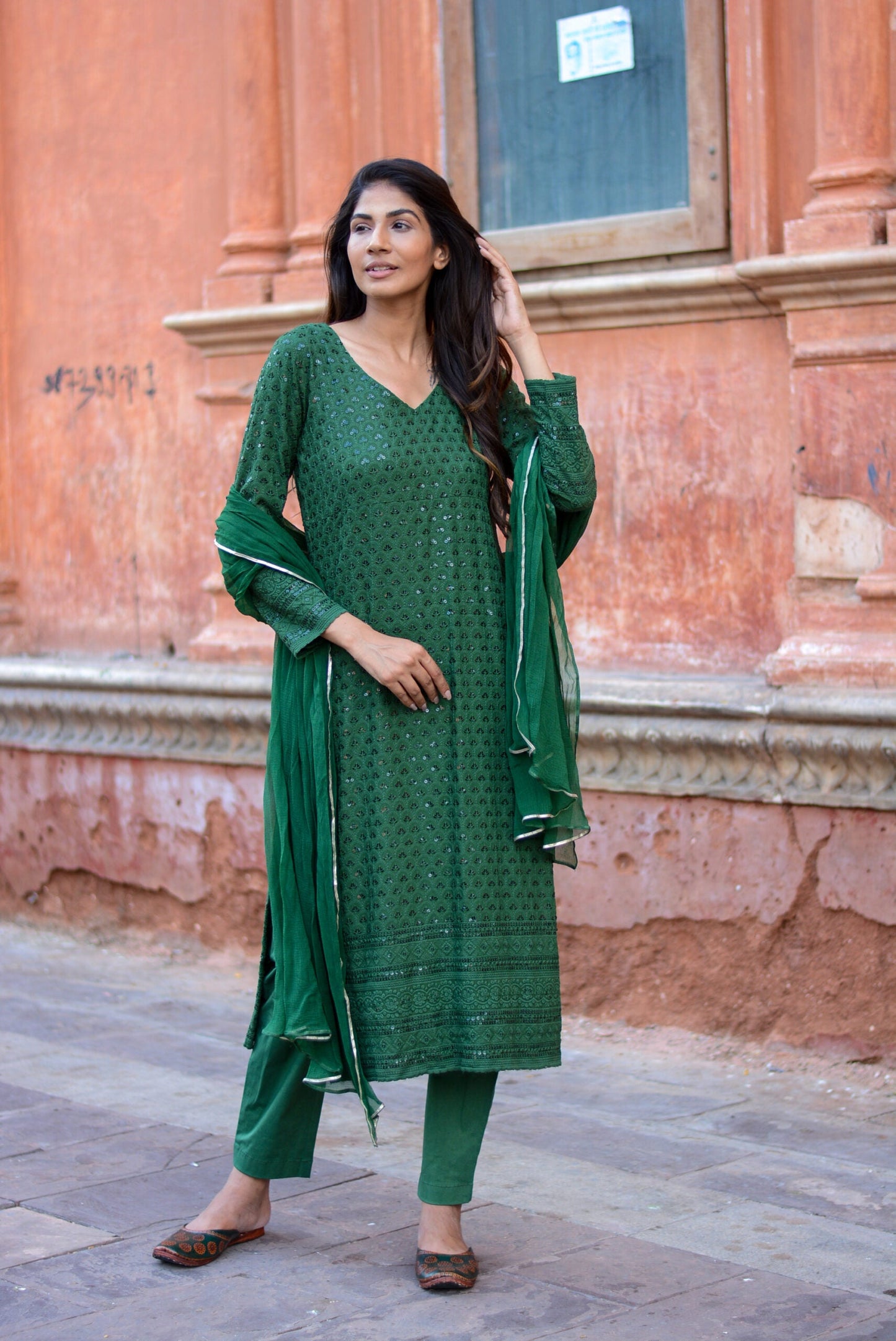 Elegant green three piece suit for women featuring detailed embroidery and matching dupatta
