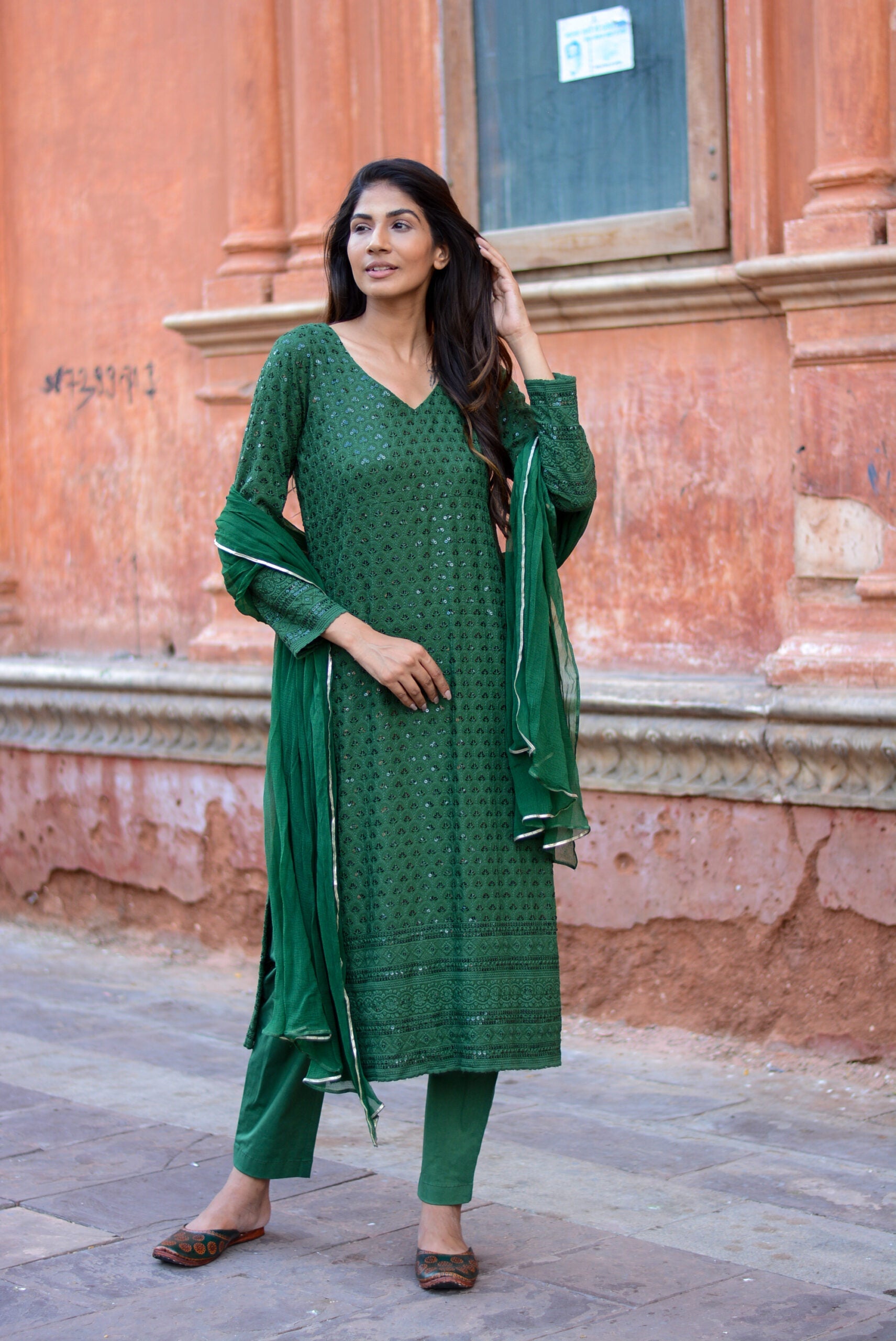Elegant green three piece suit for women featuring detailed embroidery and matching dupatta