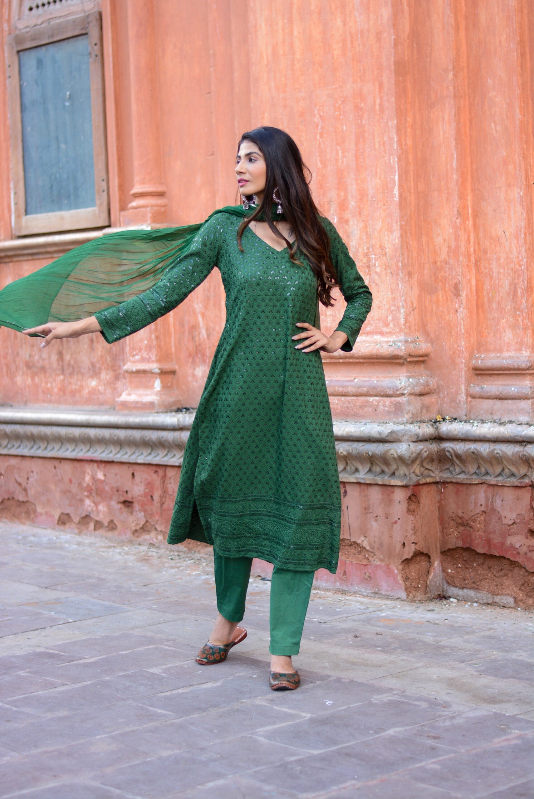 Elegant green three piece suit for women with intricate patterns and matching dupatta by Stylera