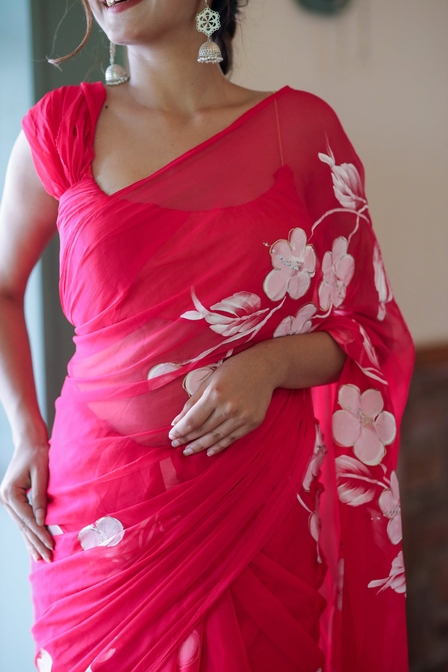 Elegant handpainted chiffon saree rani pink draped elegantly with floral designs for a sophisticated look