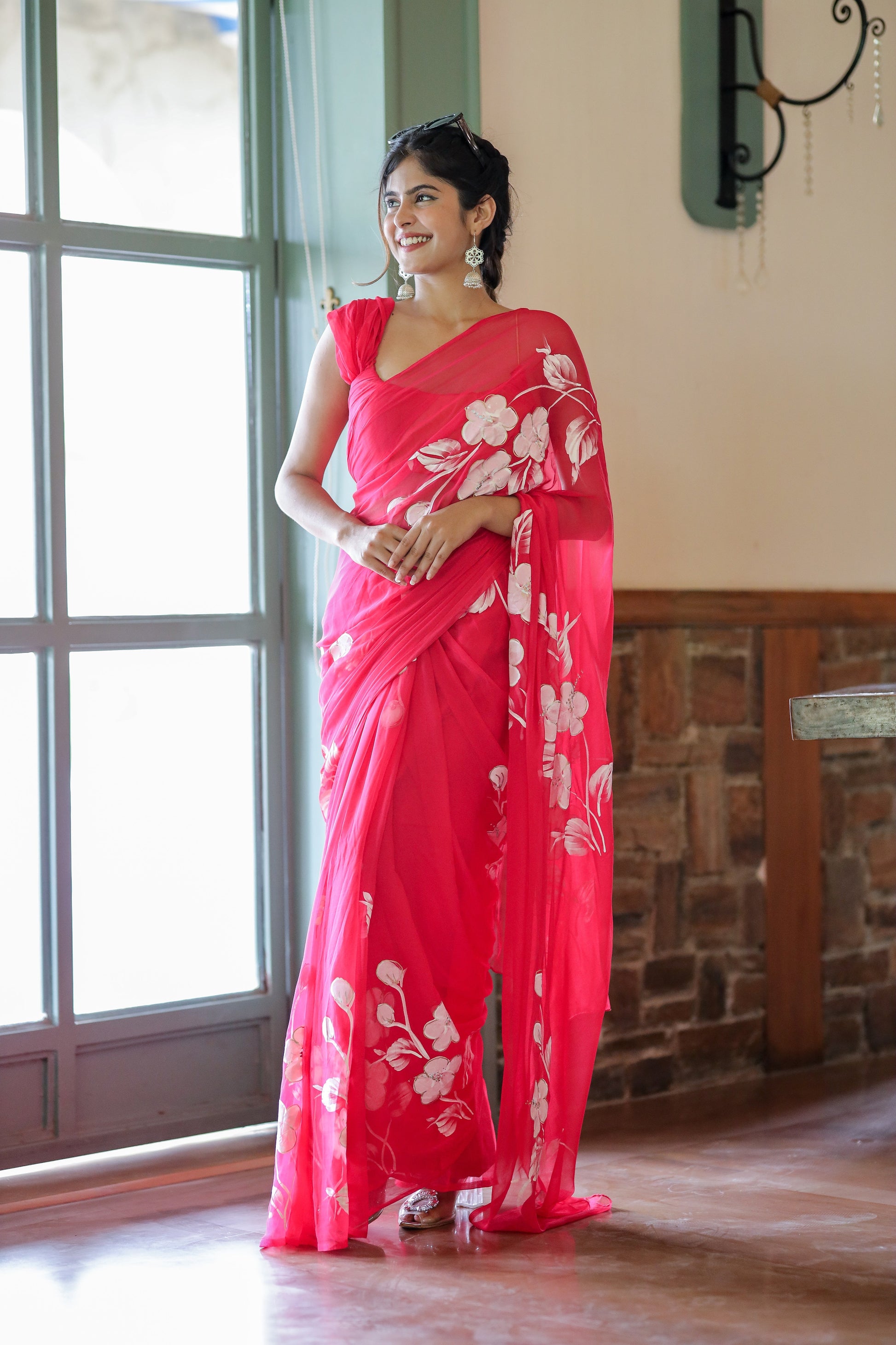 Elegant handpainted chiffon saree rani pink with floral designs, perfect for festive occasions