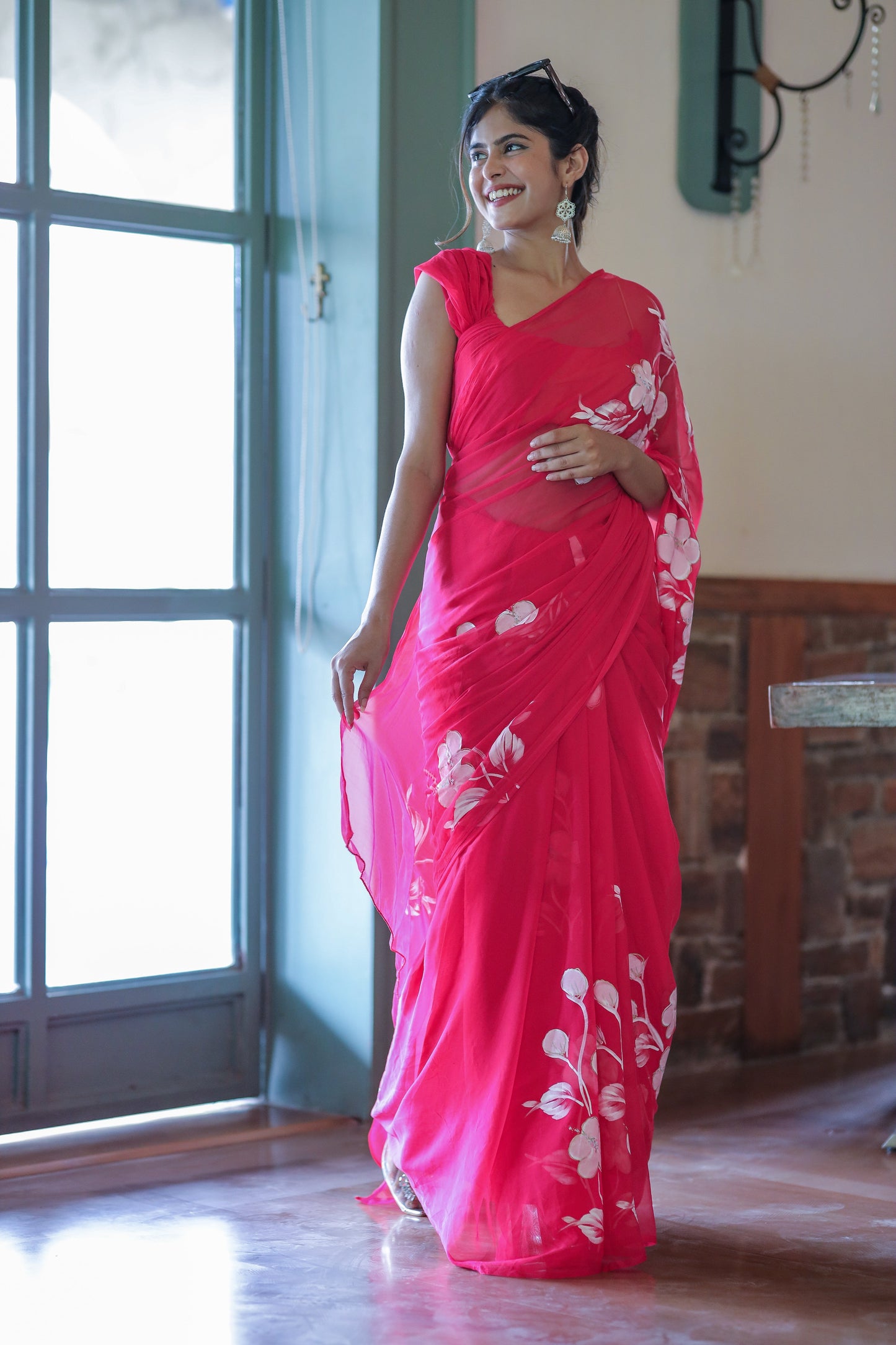 Elegant handpainted chiffon saree rani pink featuring floral designs for festive occasions