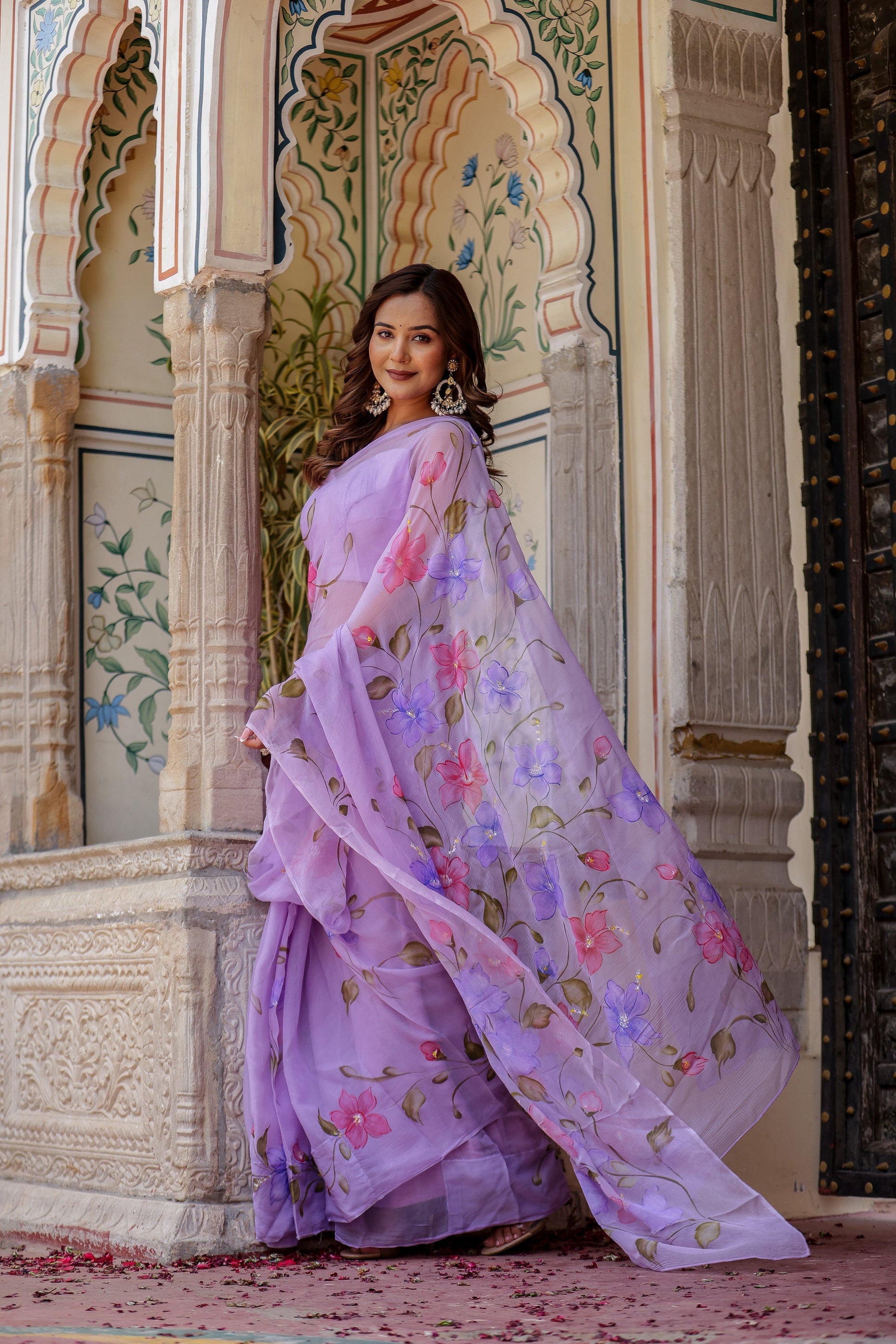 Elegant handpainted lavender chiffon saree with floral designs, perfect for festive occasions