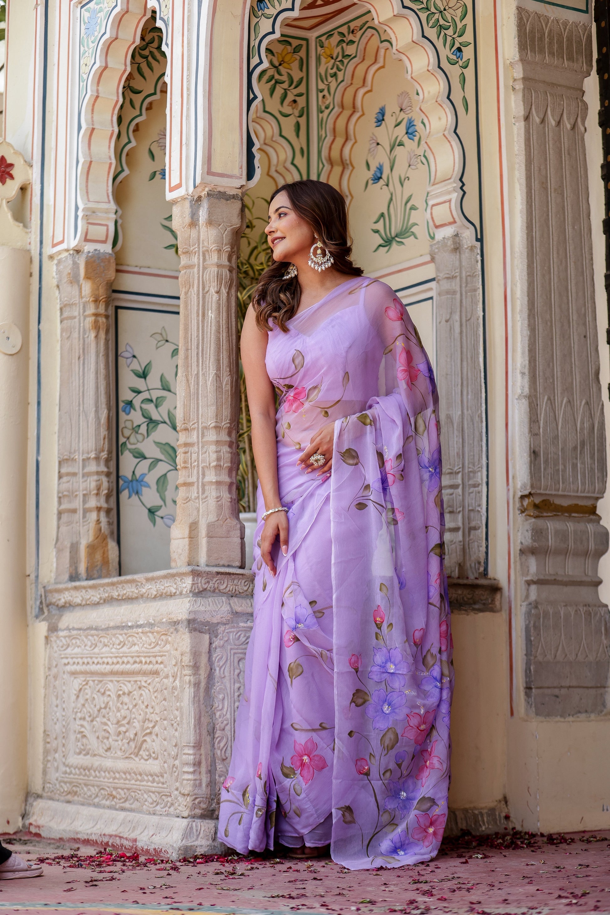 Elegant handpainted lavender chiffon saree with vibrant floral designs for festive occasions