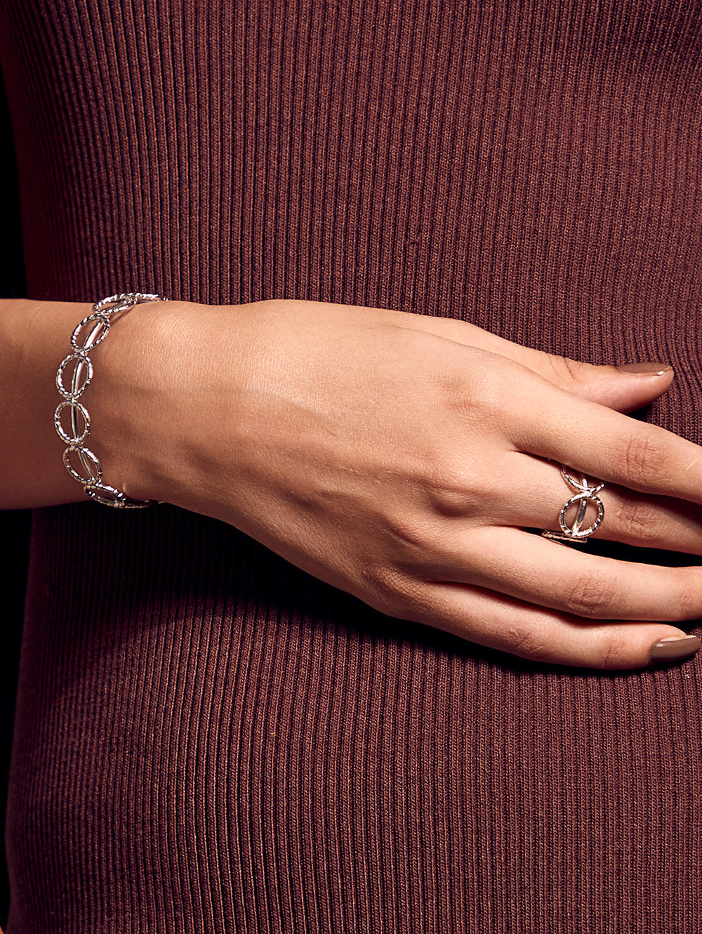 Stylera women's fashion bracelet silver chain link oval design on model wrist with matching ring