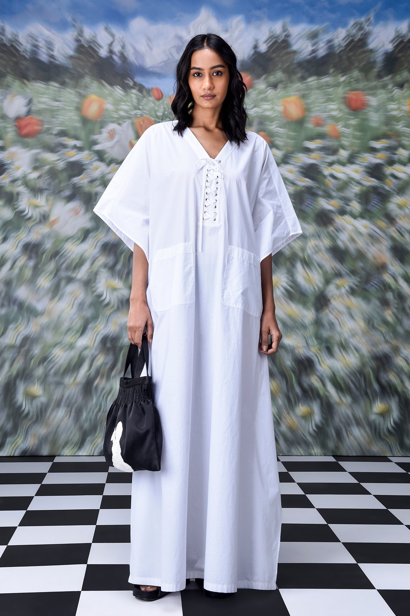 Stylera white cotton lace-up free size kaftan dress with V neck and front ties model holding black tote