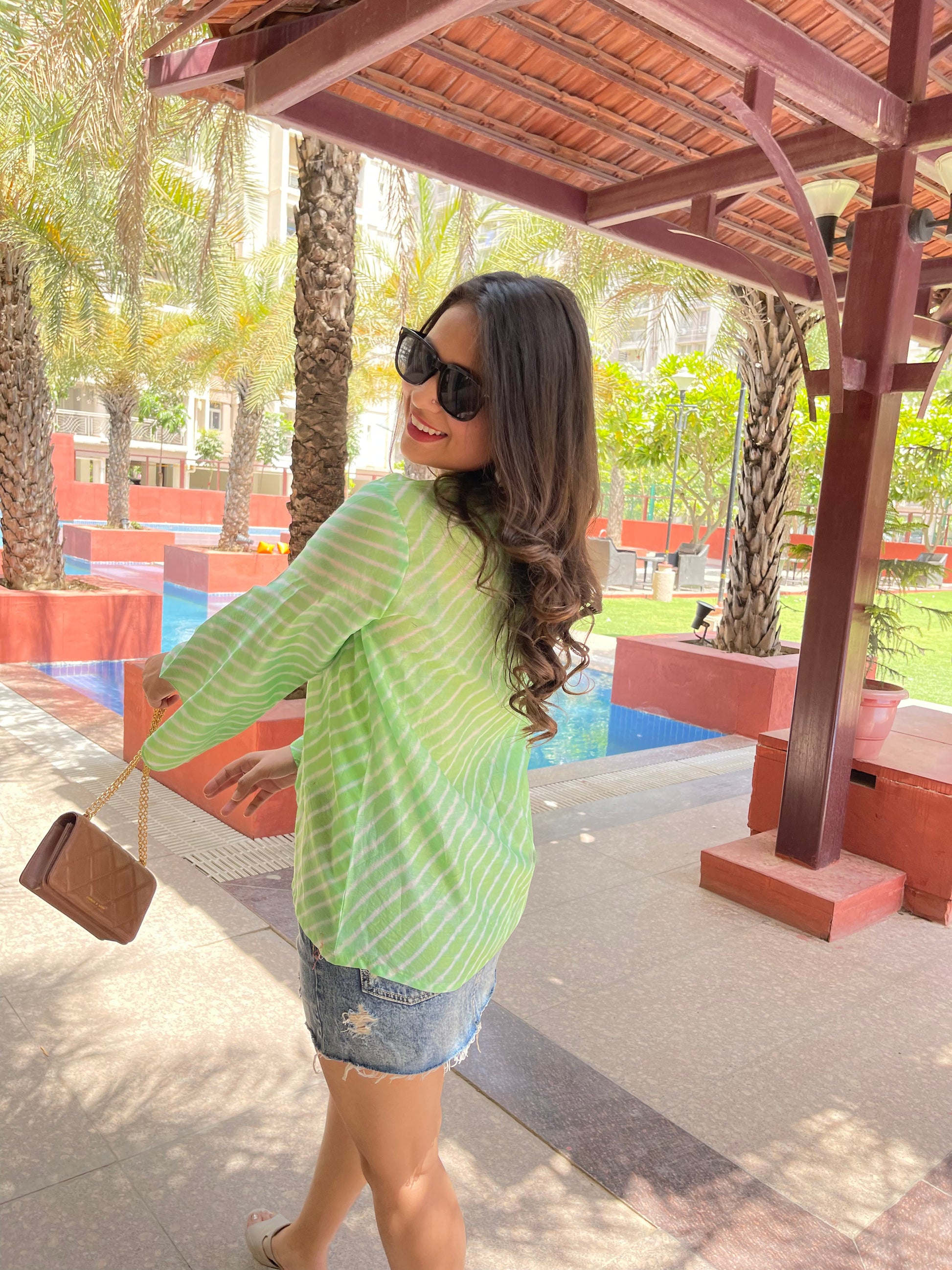 Light green lehriya print summer tops for women paired with denim shorts and sunglasses