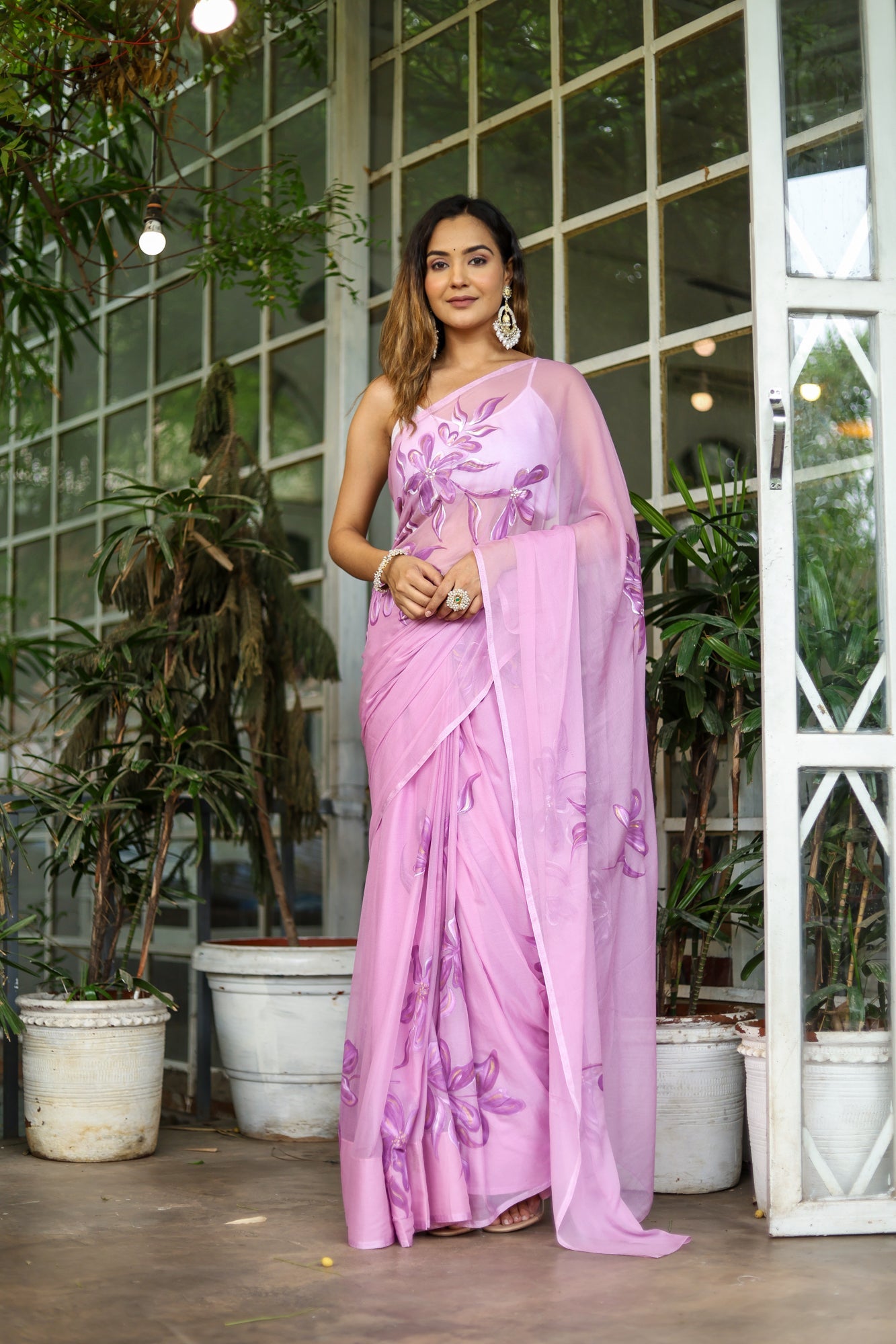 Elegant light pink floral saree with intricate designs, perfect for festive occasions and celebrations