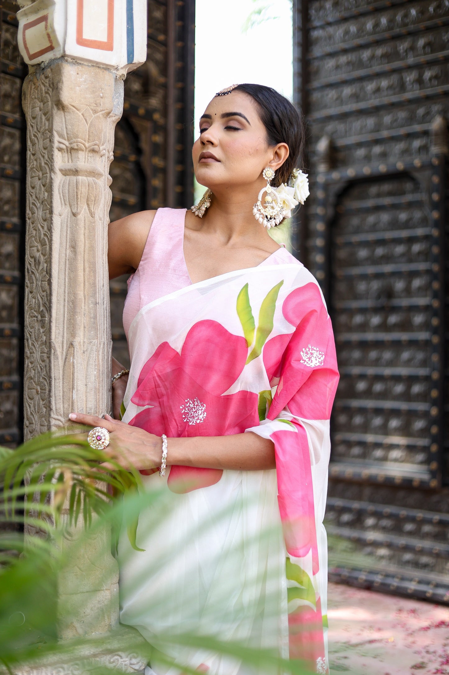 Elegant model in a lightweight party wear chiffon saree adorned with vibrant floral patterns