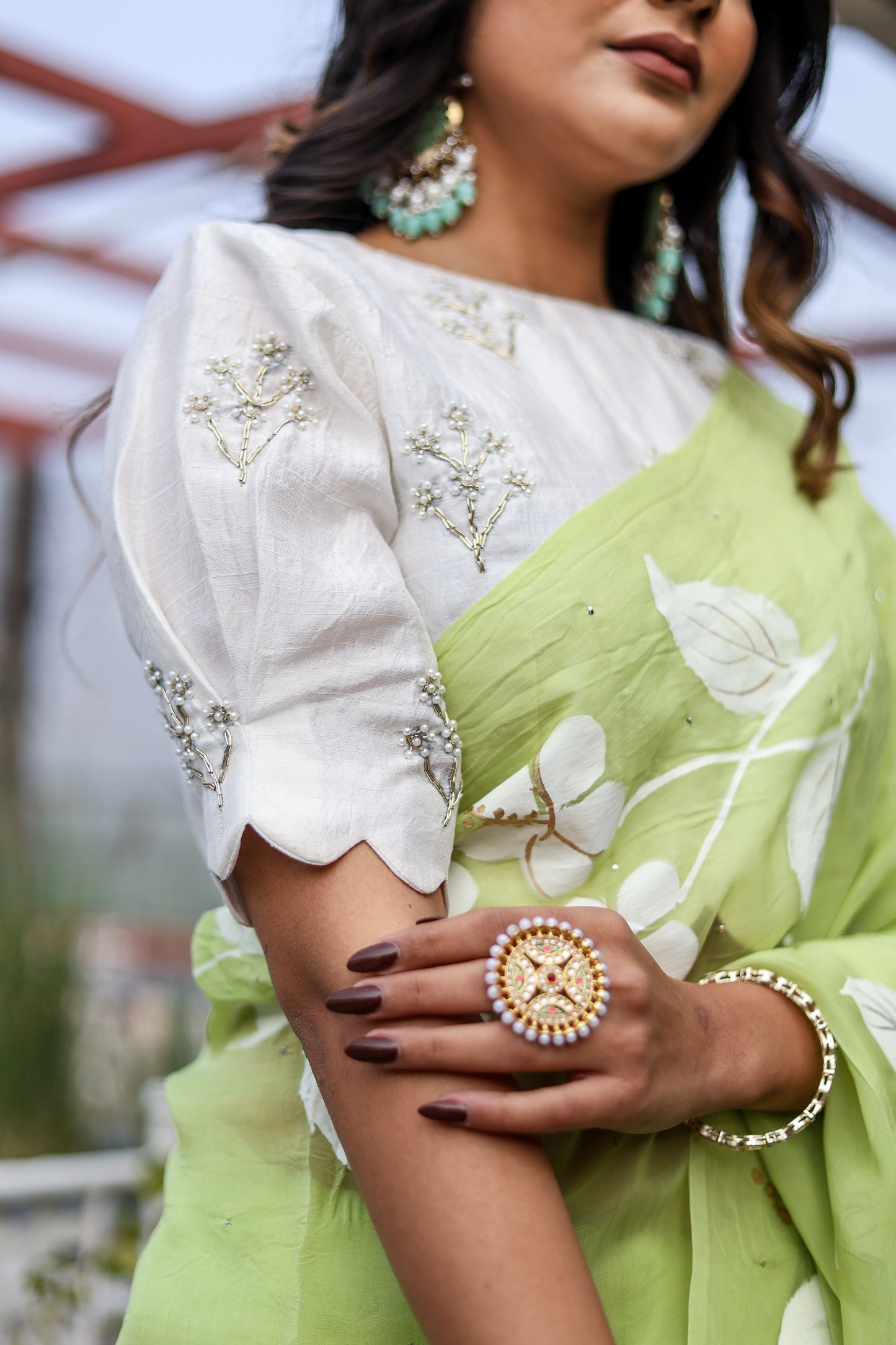 Elegant lightweight party wear saree in green with floral design, paired with a stylish blouse and accessories