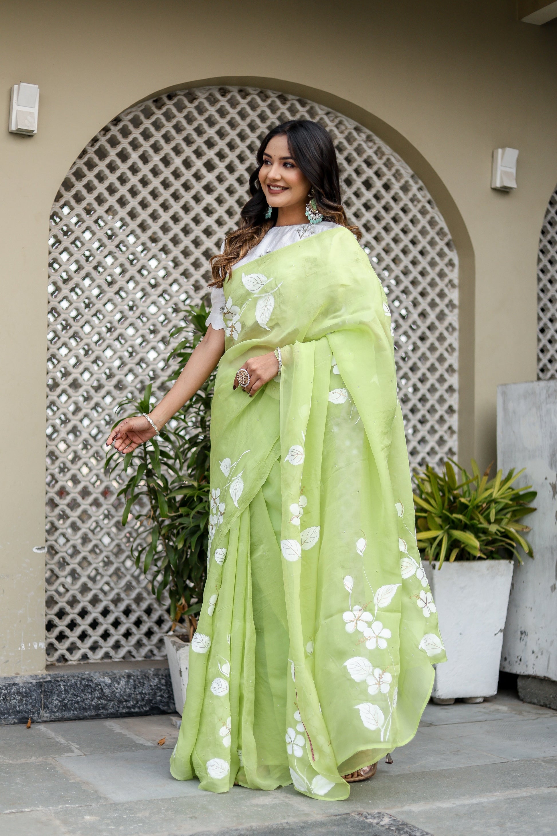 Lightweight party wear saree in light green with floral embroidery, perfect for festive occasions