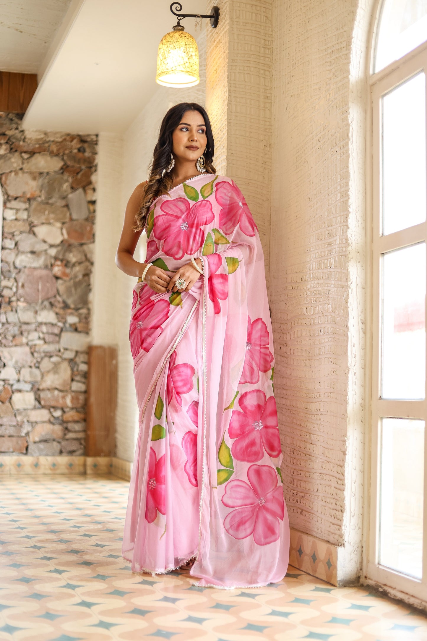 Lightweight party wear saree in pink with floral prints, perfect for festive occasions