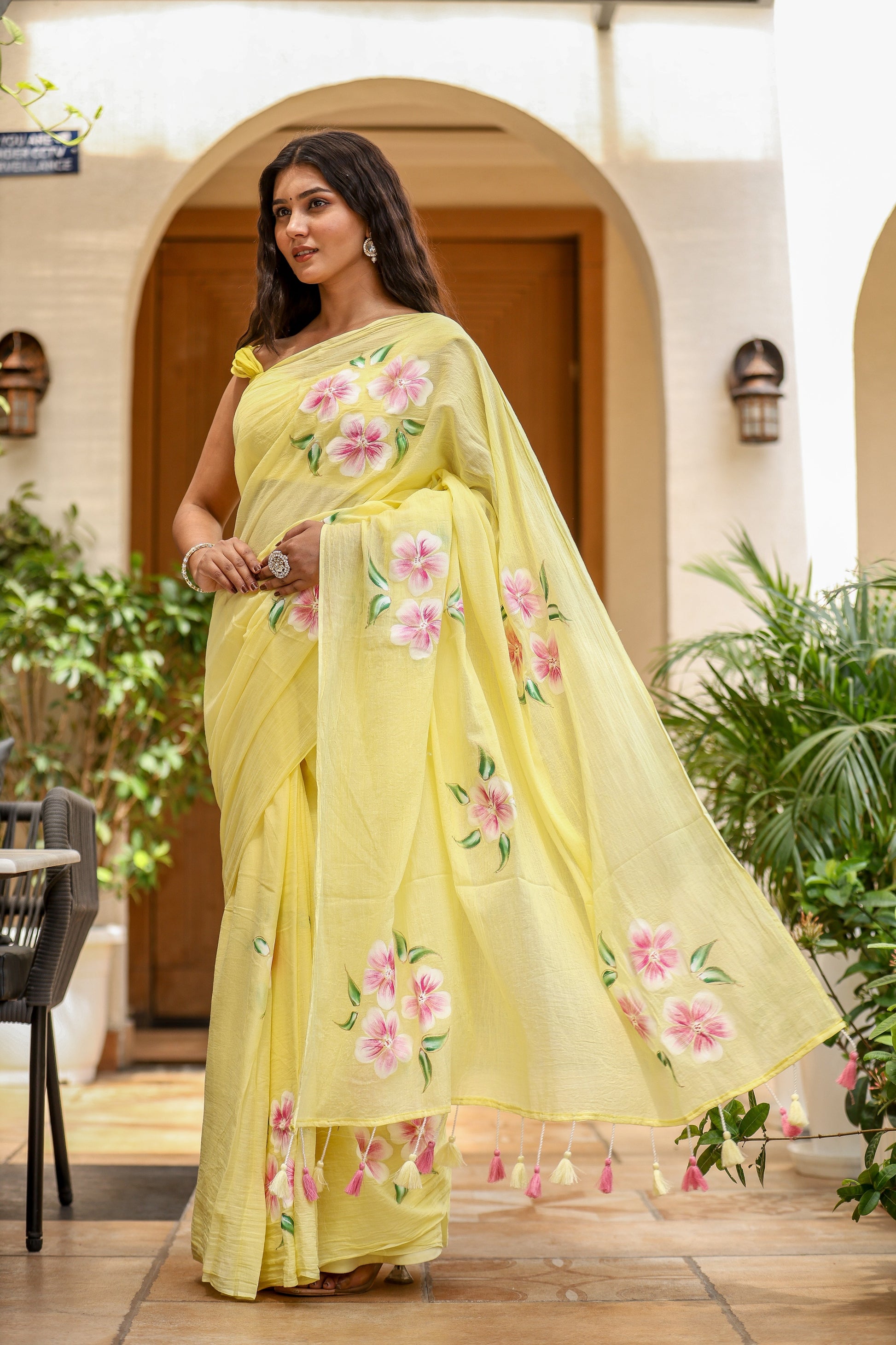 Elegant lightweight party wear saree in yellow with floral prints and tassel details
