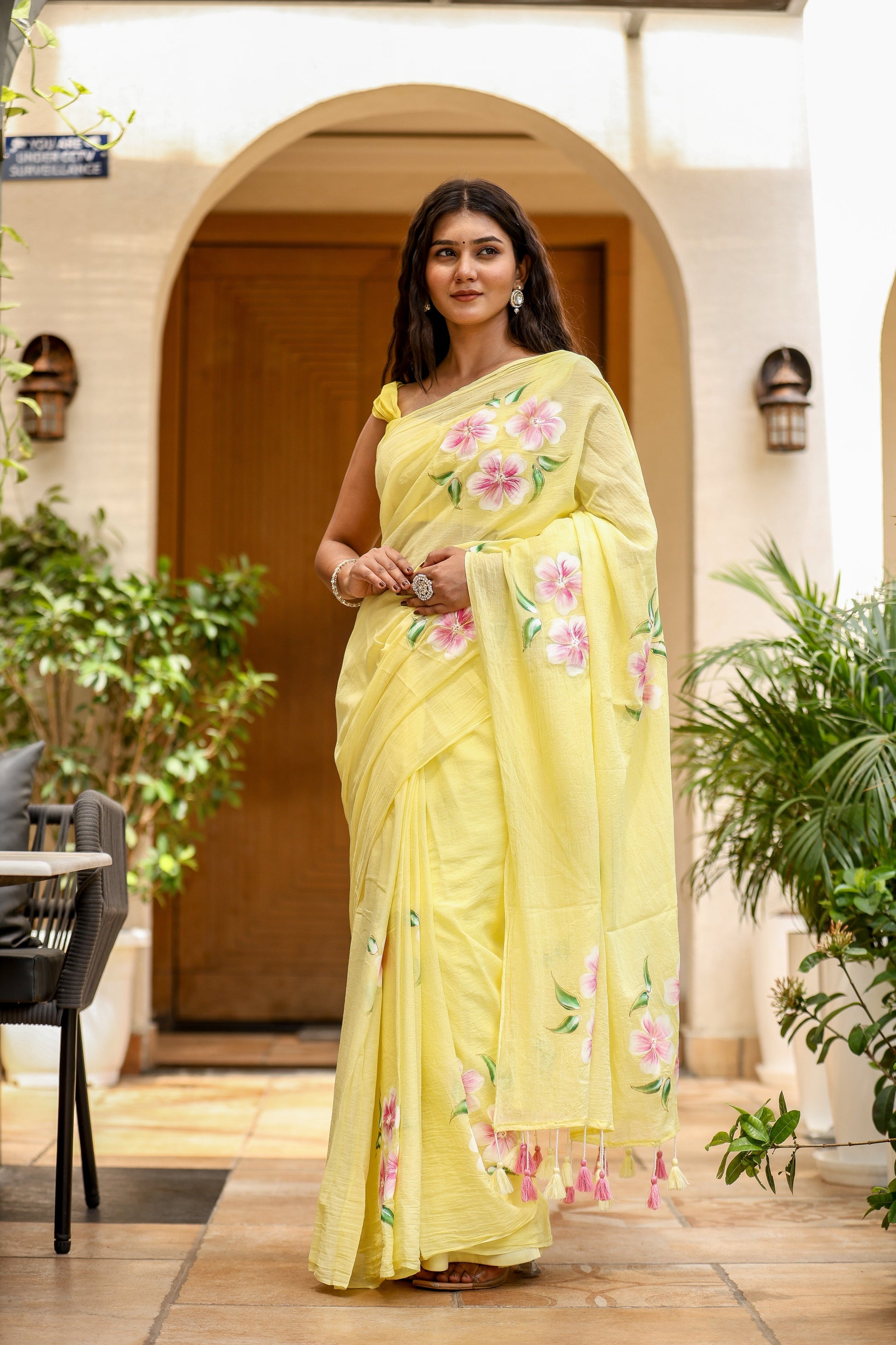 Stylera lightweight party wear saree in yellow with floral patterns and elegant tassels