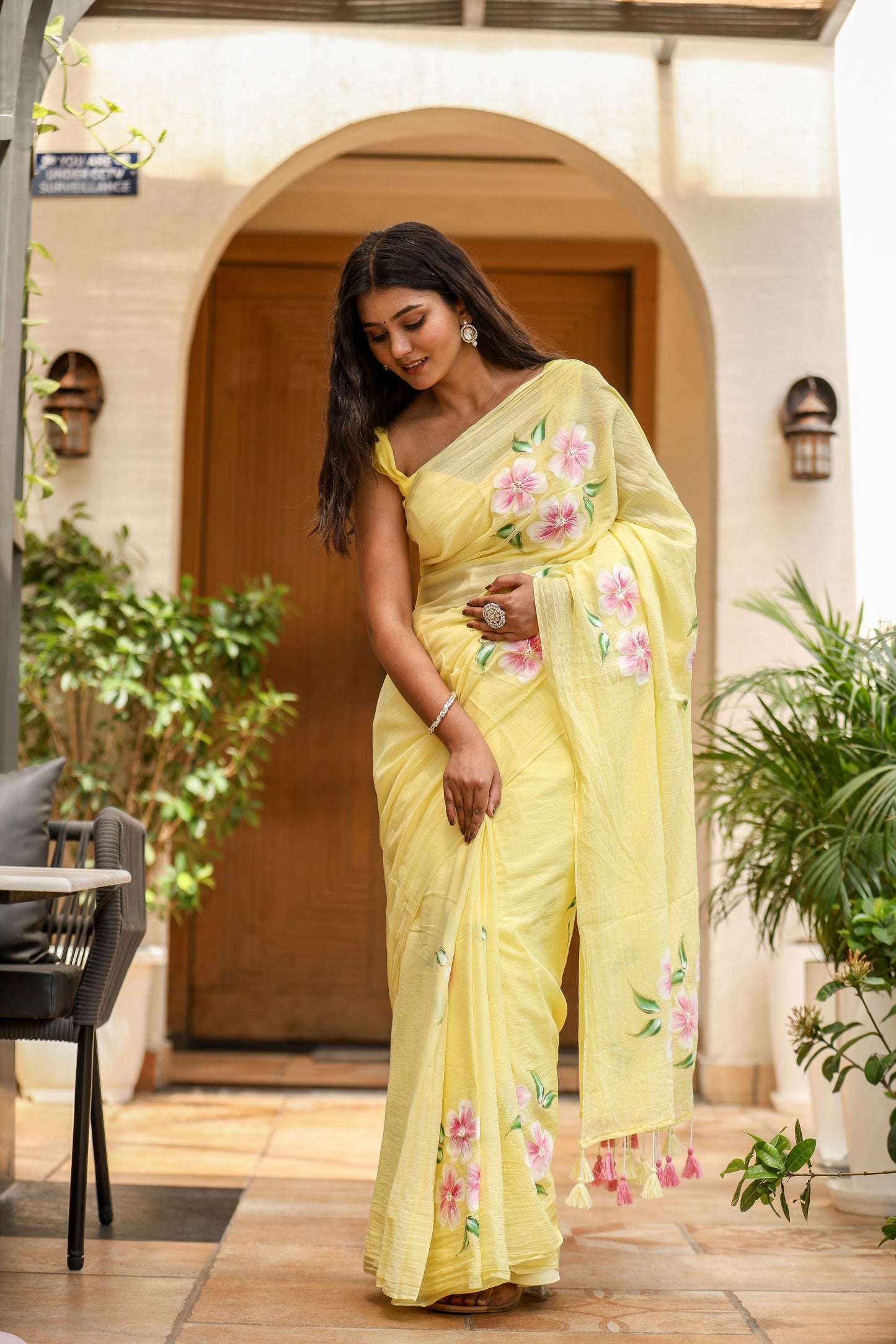 Elegant lightweight party wear saree in yellow with floral details, perfect for festive occasions.