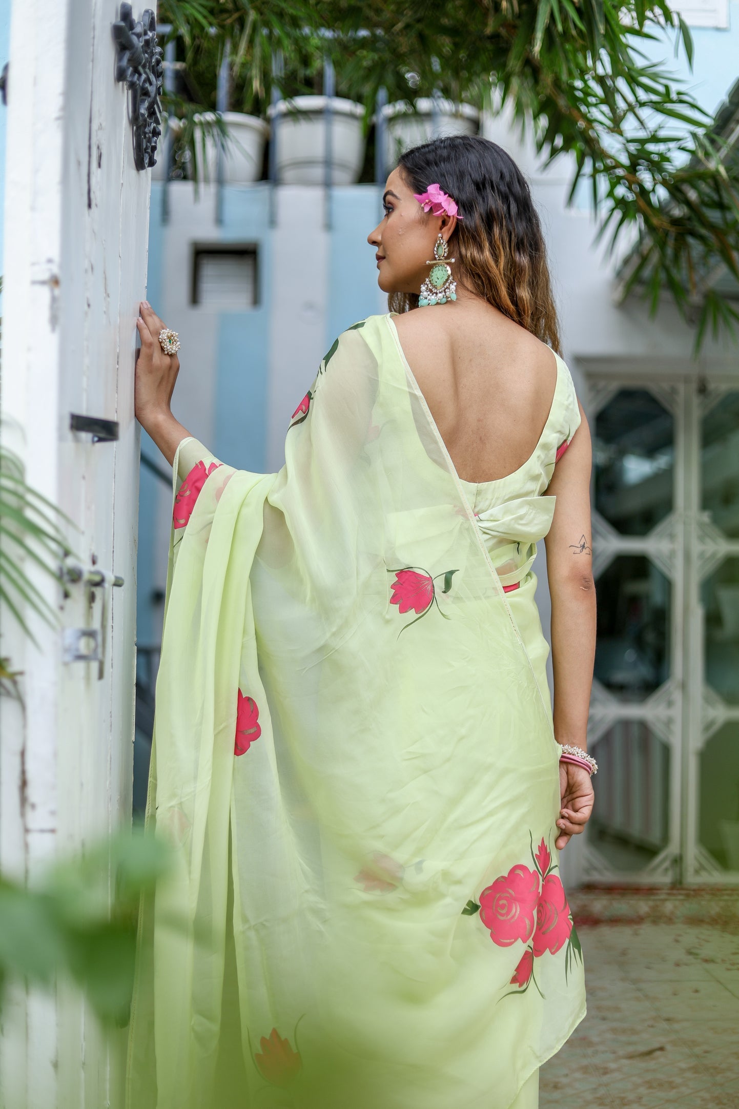 Elegant lightweight pastel saree with floral print showcasing a model in a beautiful outdoor setting