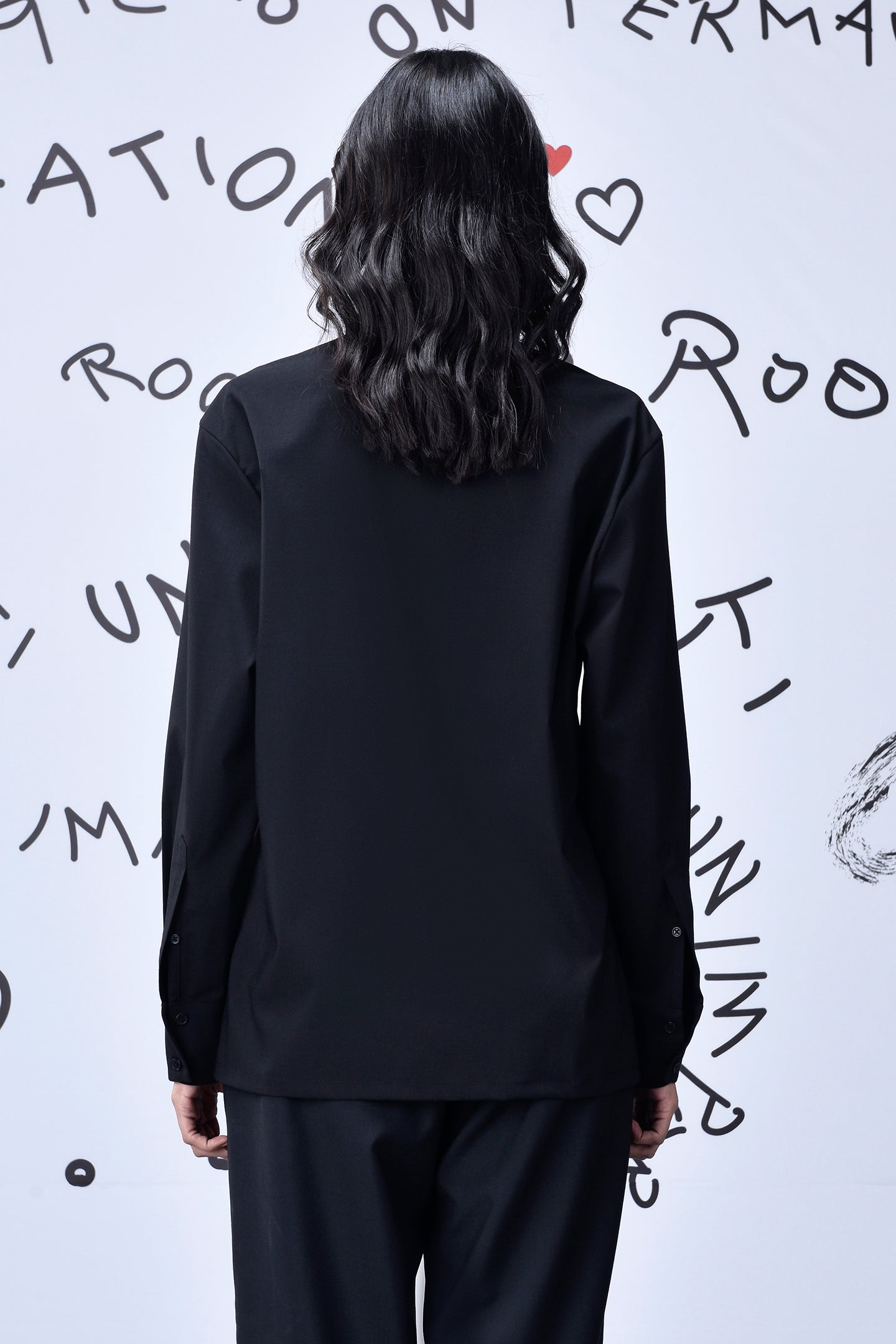 Back view of black Mad Hatter wool shirt by Stylera long sleeve tailored design on model