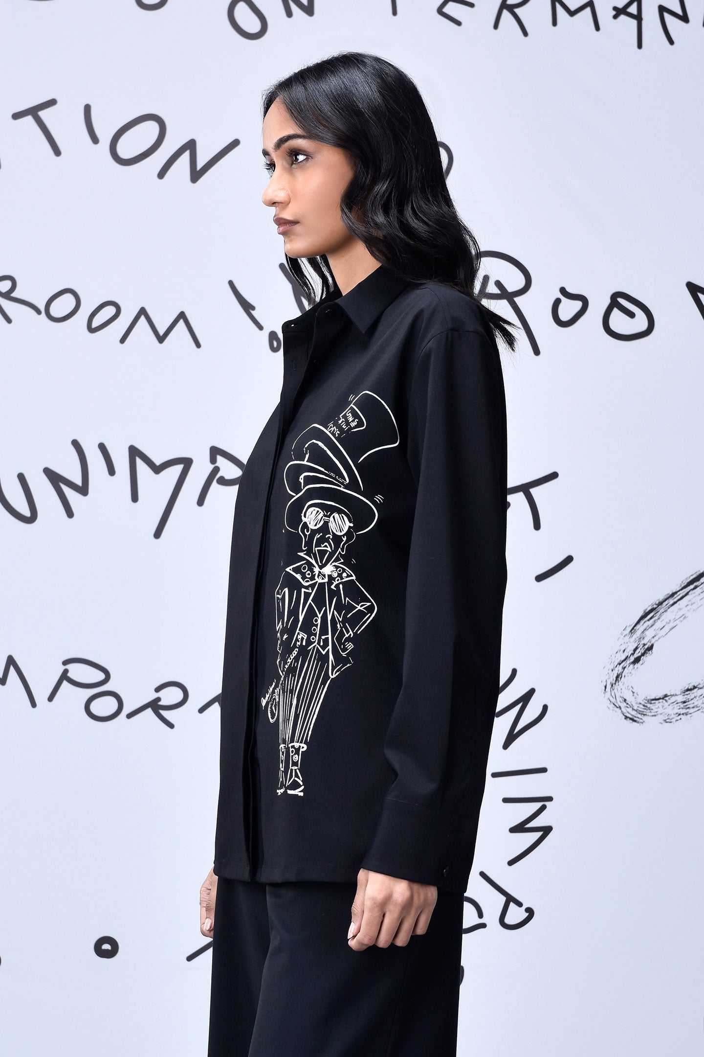 Stylera black button down shirt with white illustration on side modeled in profile Mad Hatter wool shirt