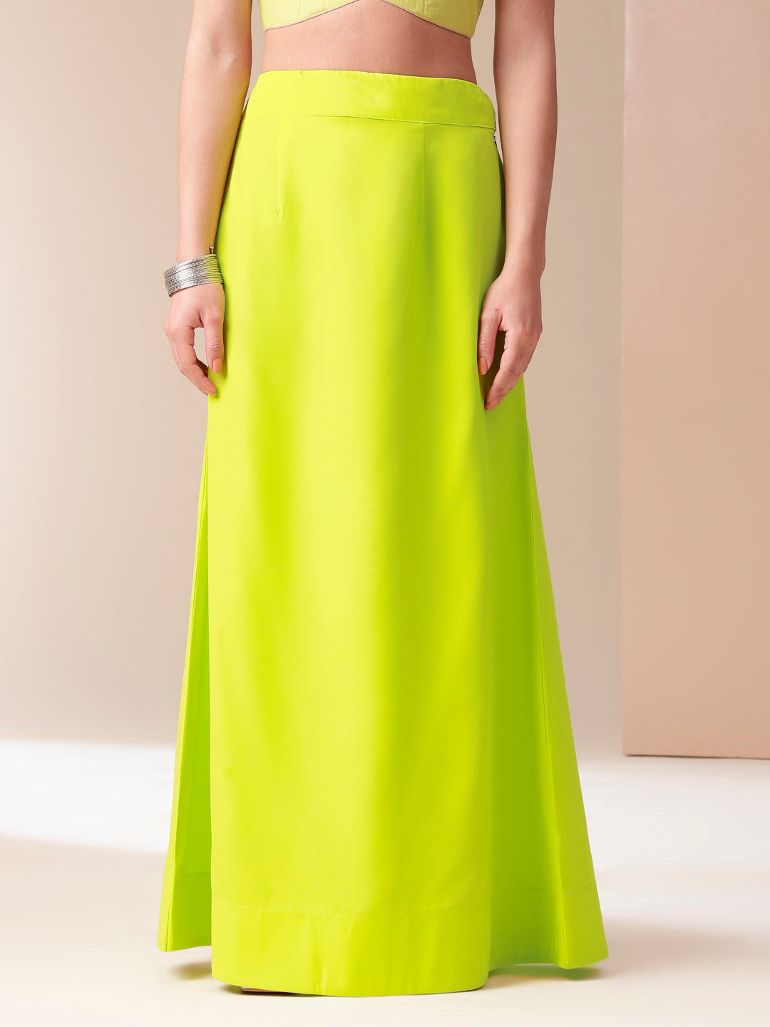 Bright neon green mal mal saree for women featuring a smooth finish and elegant draping style