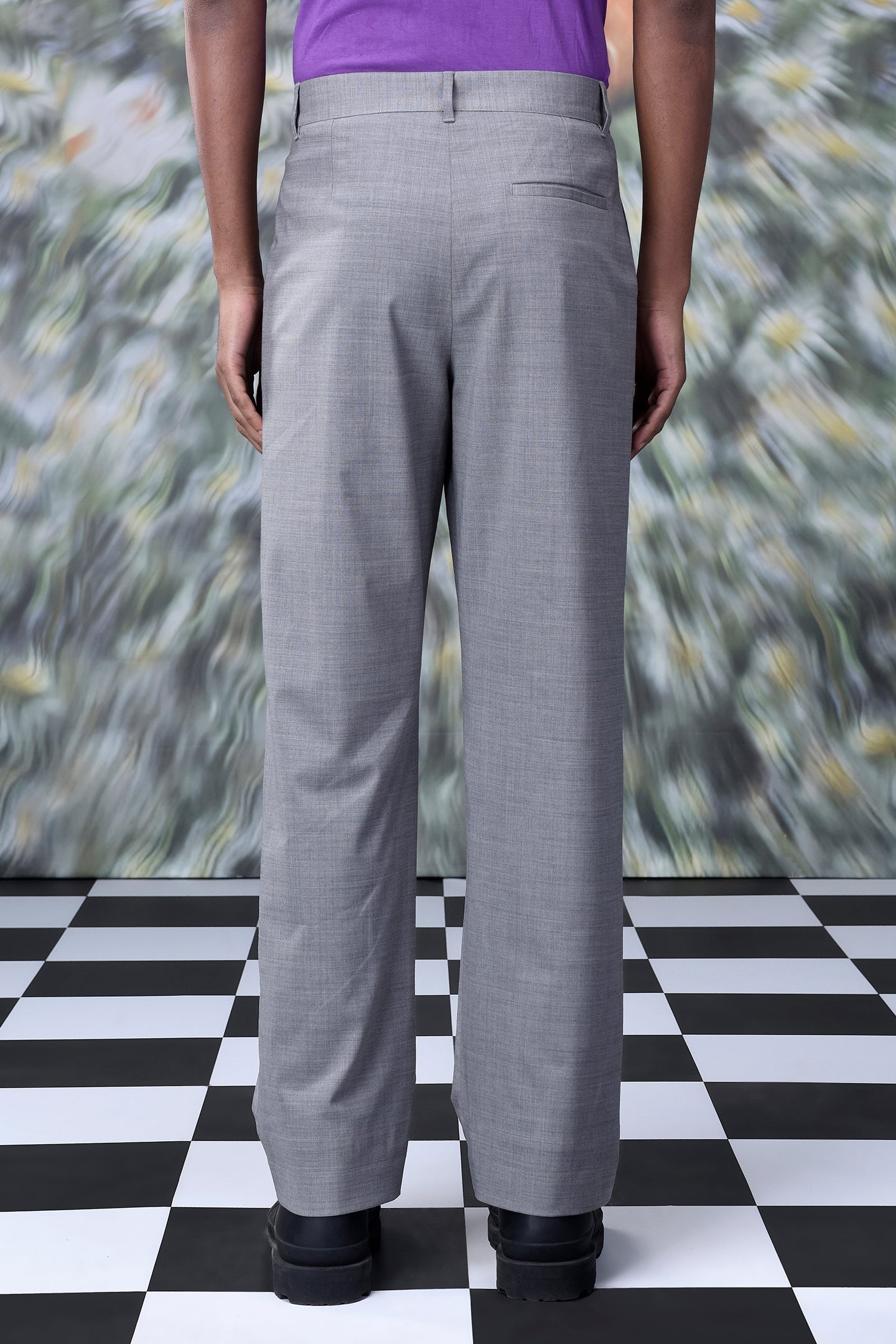 Back view of gray men's business casual trousers by Stylera worn with black shoes