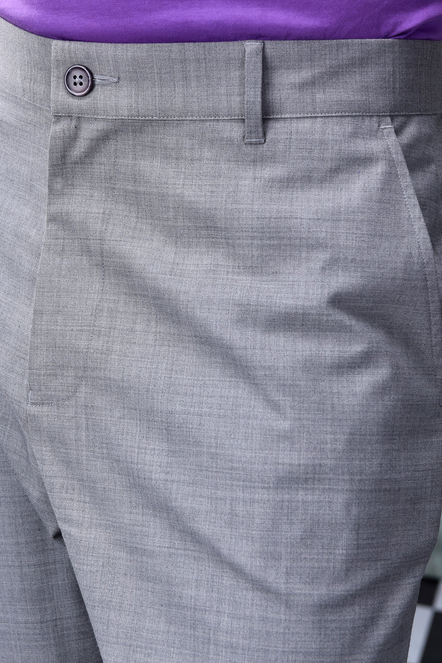 Close-up of gray men's business casual trousers by Stylera with button closure and belt loop
