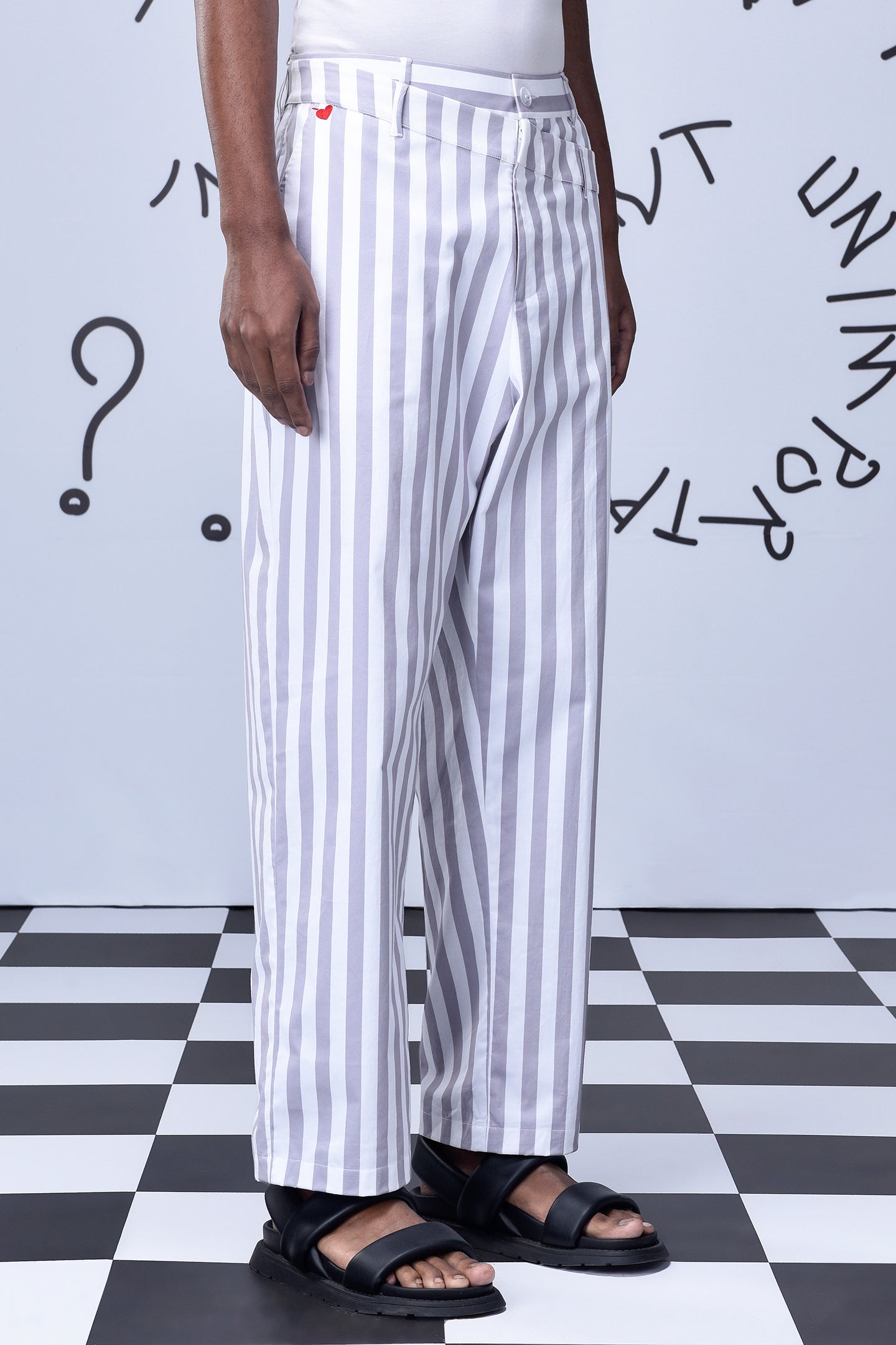 Stylera men's striped lounge pants in white and gray vertical stripes styled with black sandals