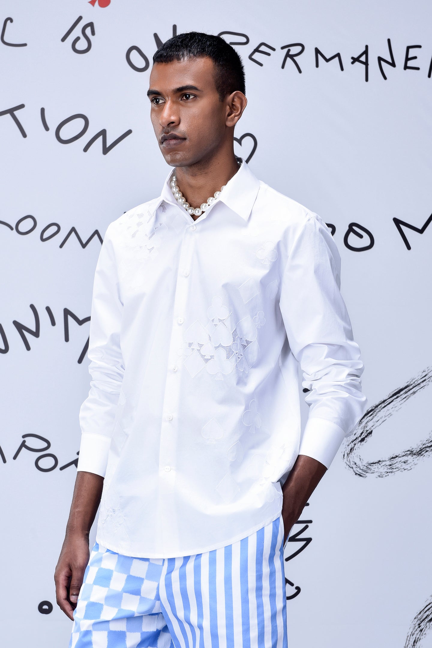 Men wearing Stylera men's trendy white shirt with subtle embroidery and pearl necklace
