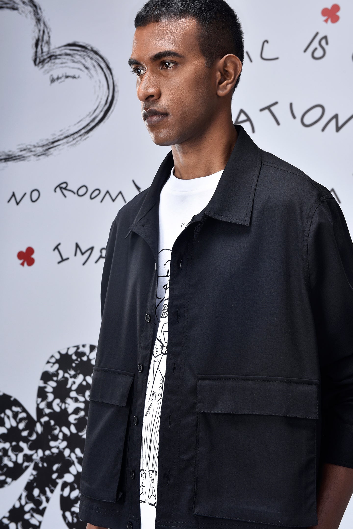 Stylera black casual jacket men's modeled on a man over white graphic tee with flap pockets and relaxed collar