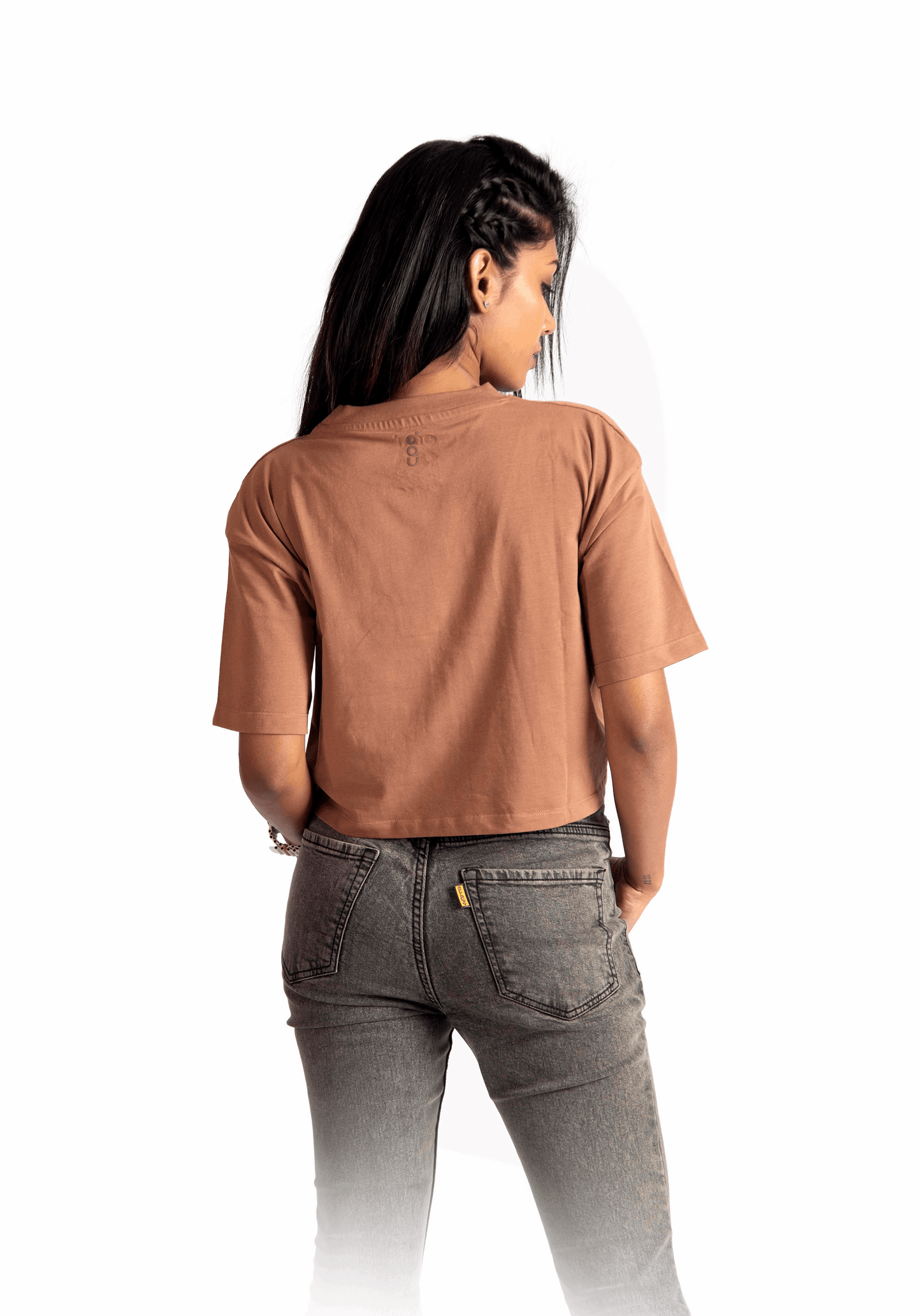 Stylera mocha oversized crop top worn by a woman shown from the back with gray jeans
