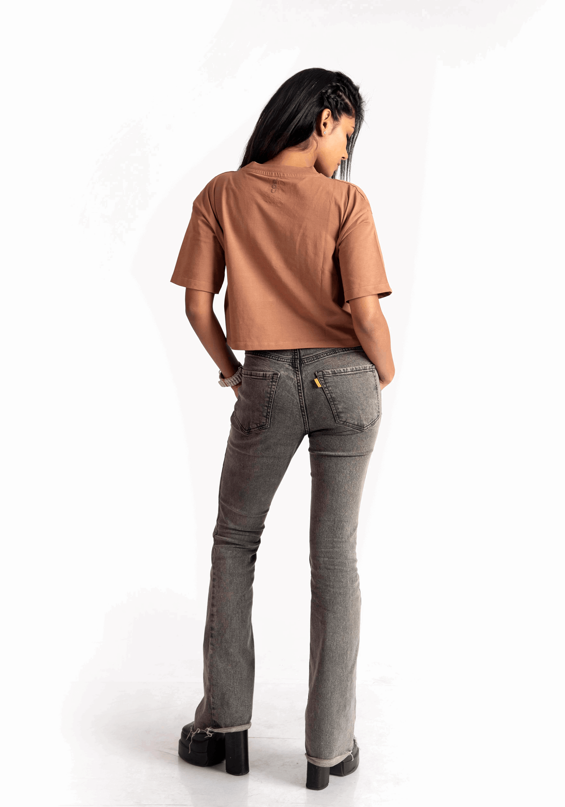 Stylera mocha oversized crop top worn by woman paired with gray jeans and black shoes